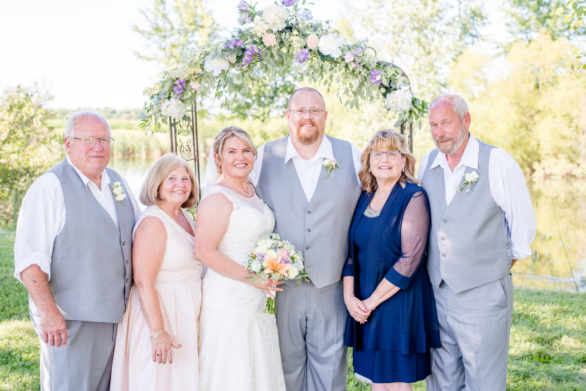 Family Members Smile During Portraits After Wedding Ceremony