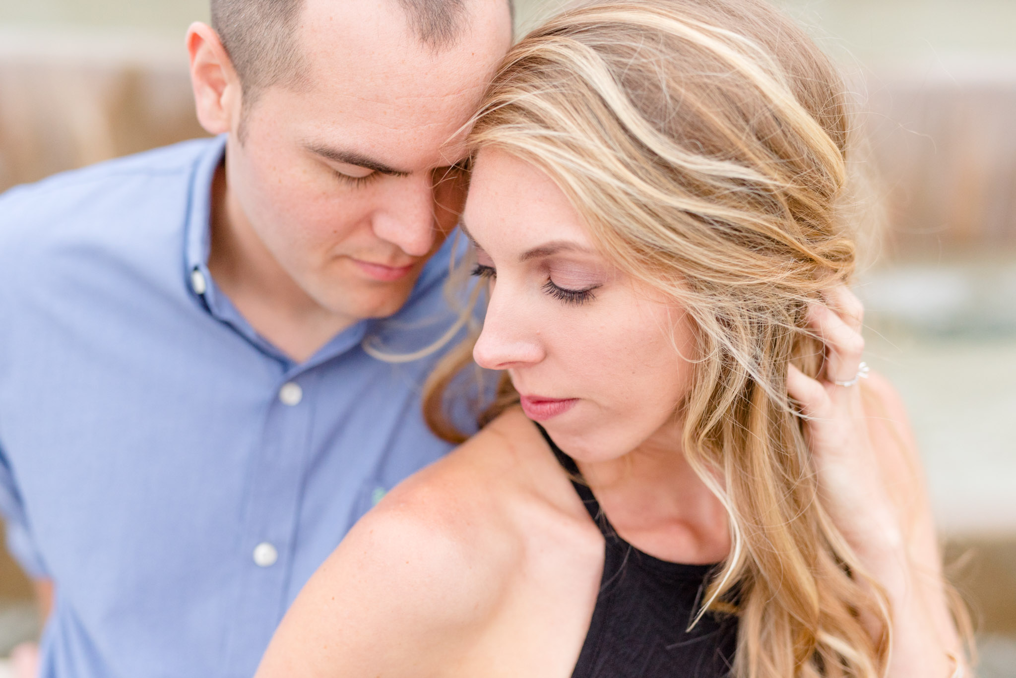 Man and woman lean heads together