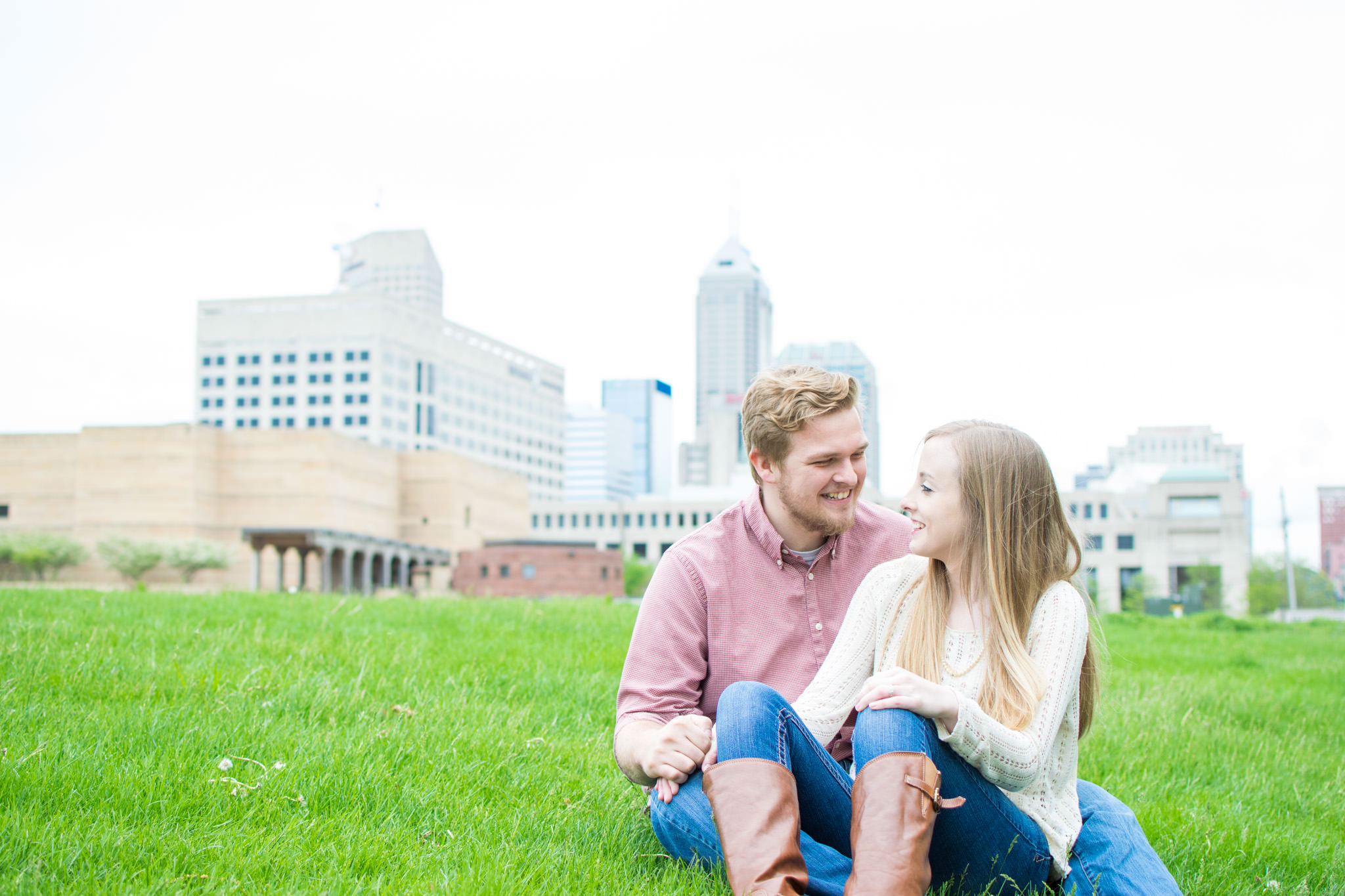 couple laughs with view of indianapolis skyline