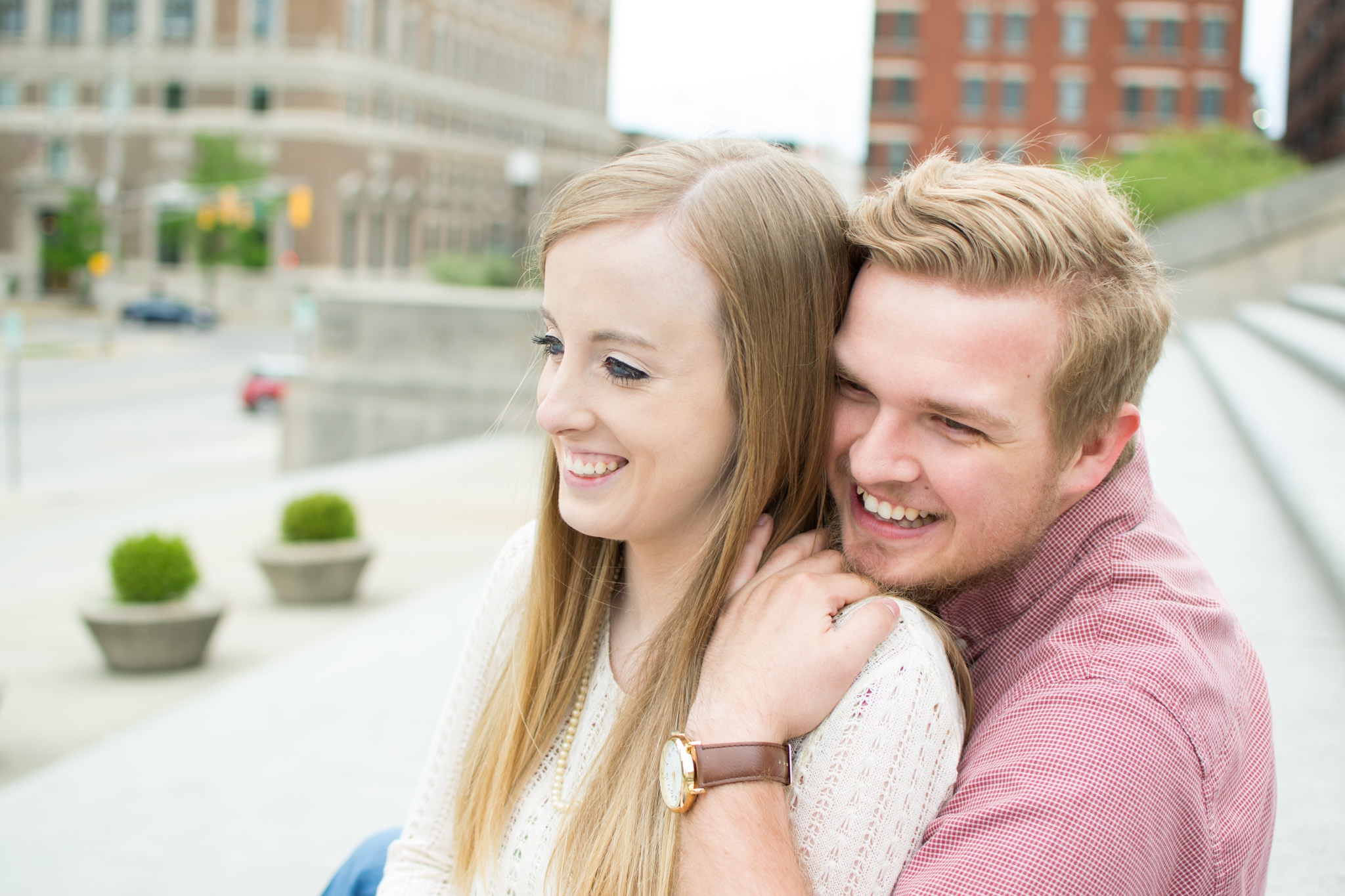 couple laughs during indiana war memorial engagement session
