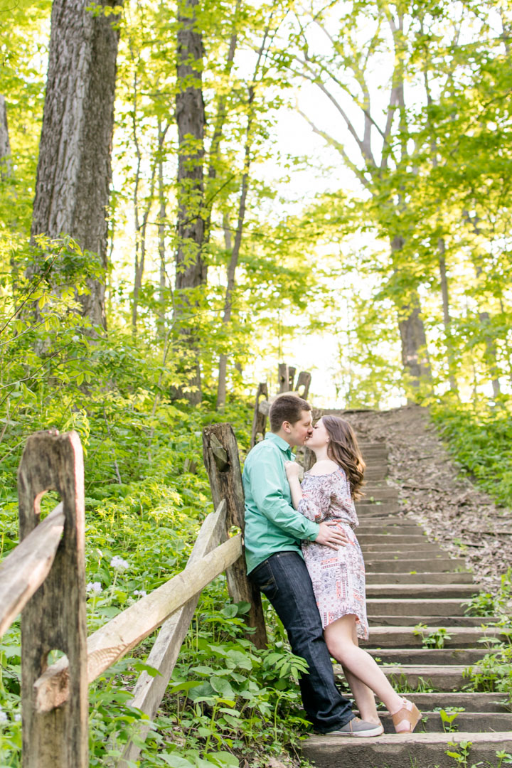 Indinapolis couple kisses on stairs at Starkey Nature Park