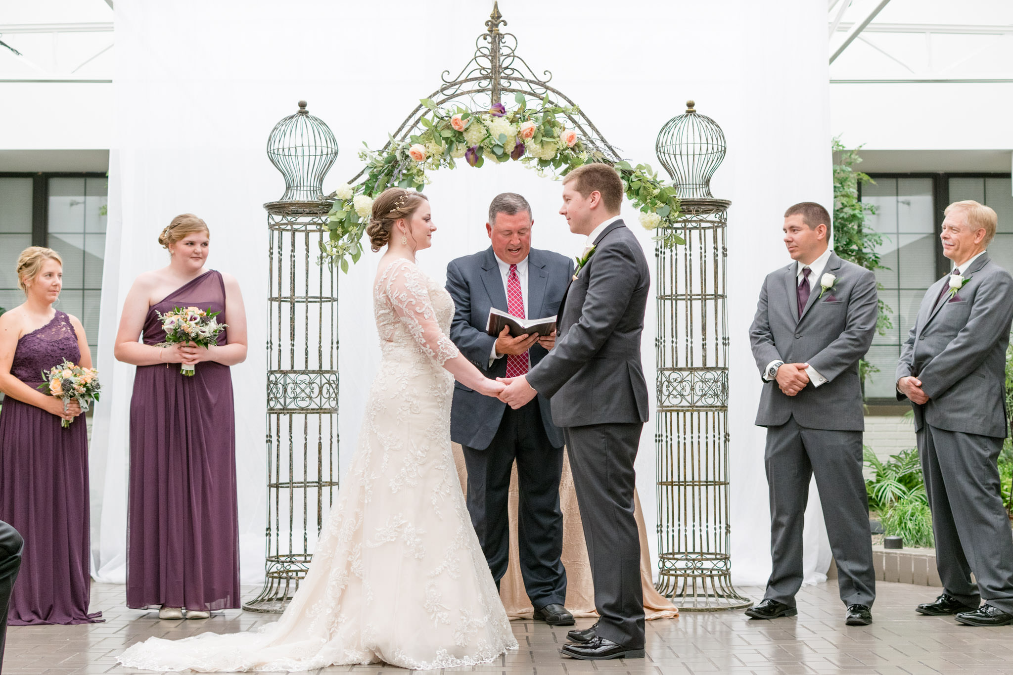 Bride and groom say vows during wedding ceremony at Marott