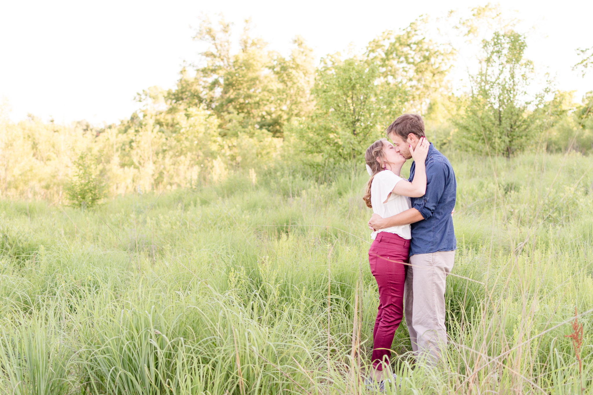 Indianapolis couple kisses in West Park field in Carmel, Indiana