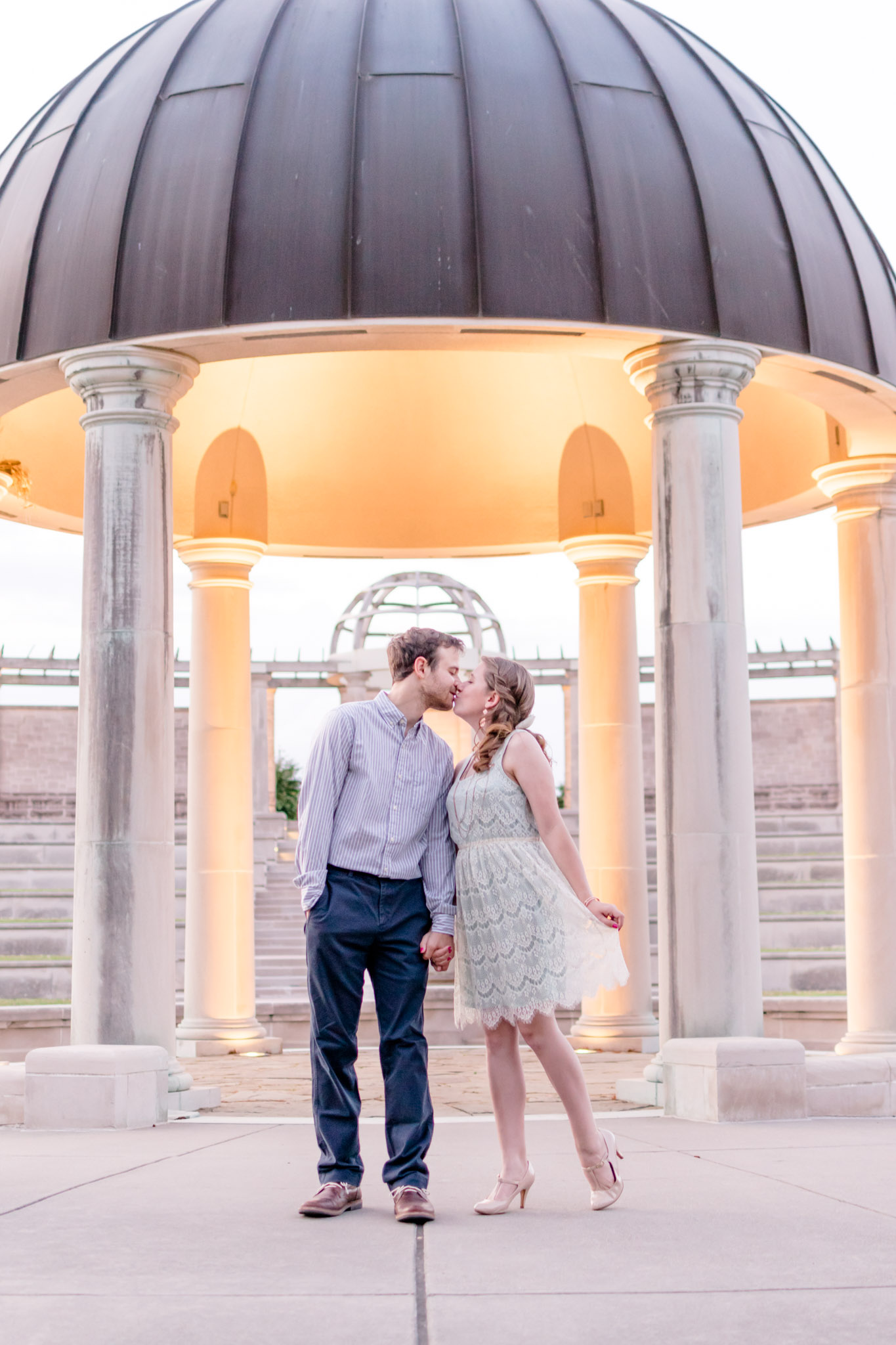 Couple kisses at amphitheater at Coxhall Gardens in Carmel, Indiana