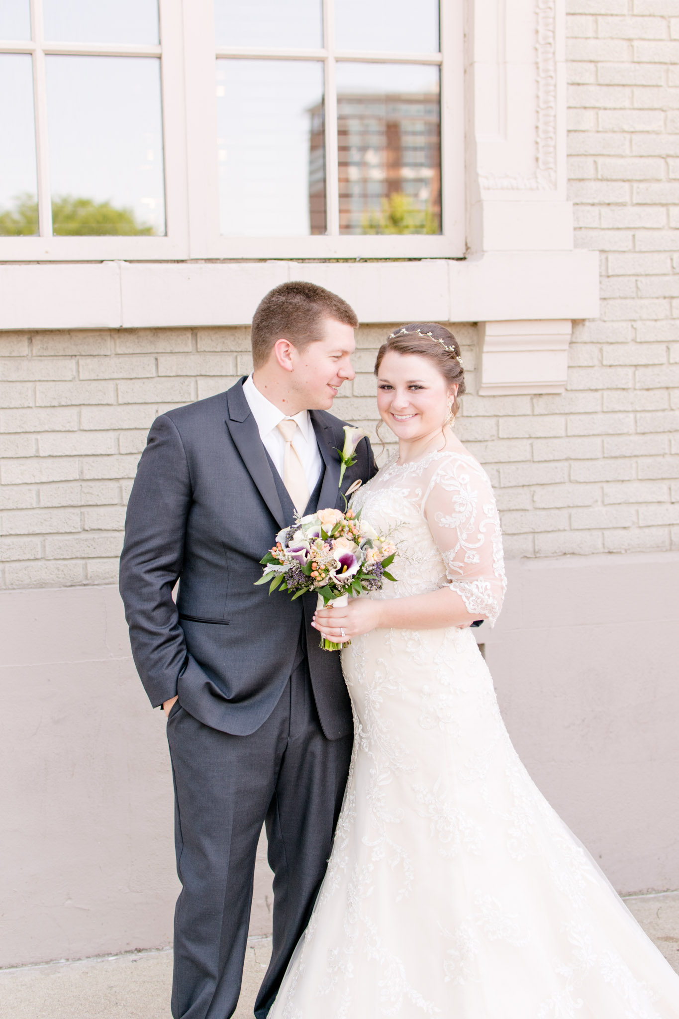 Groom smiles at Bride during wedding photos