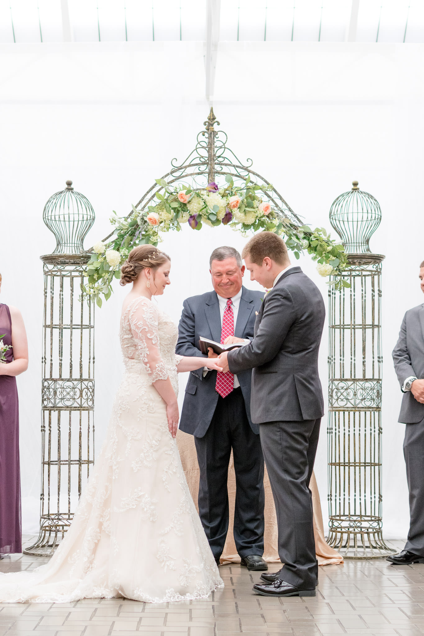 Groom puts ring on Bride during Indianapolis Wedding ceremony