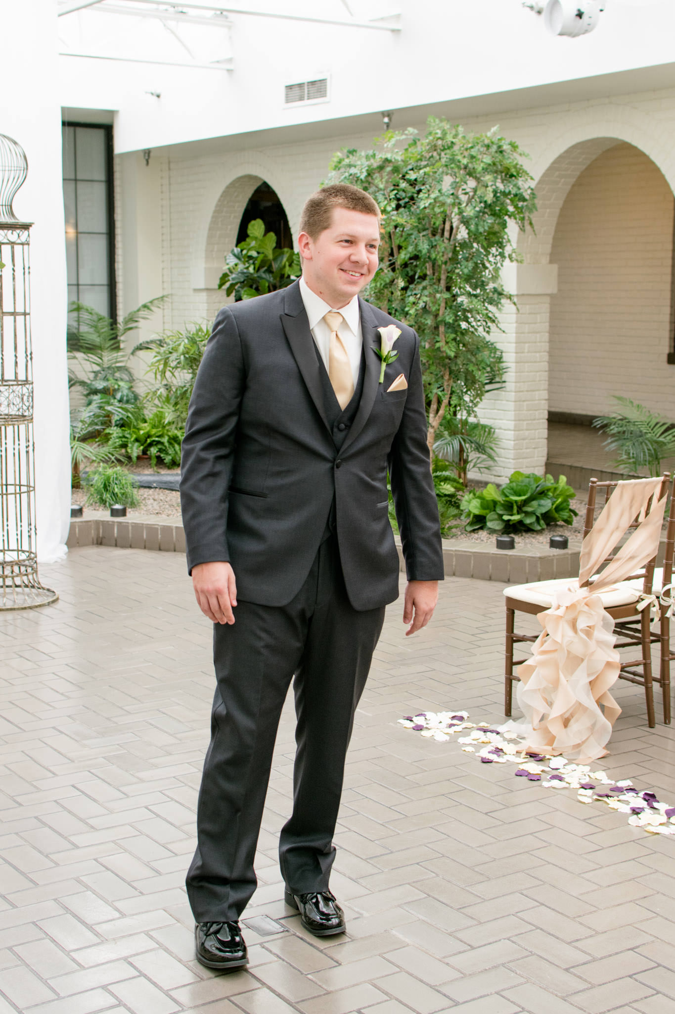 Groom smiles at bride during first look