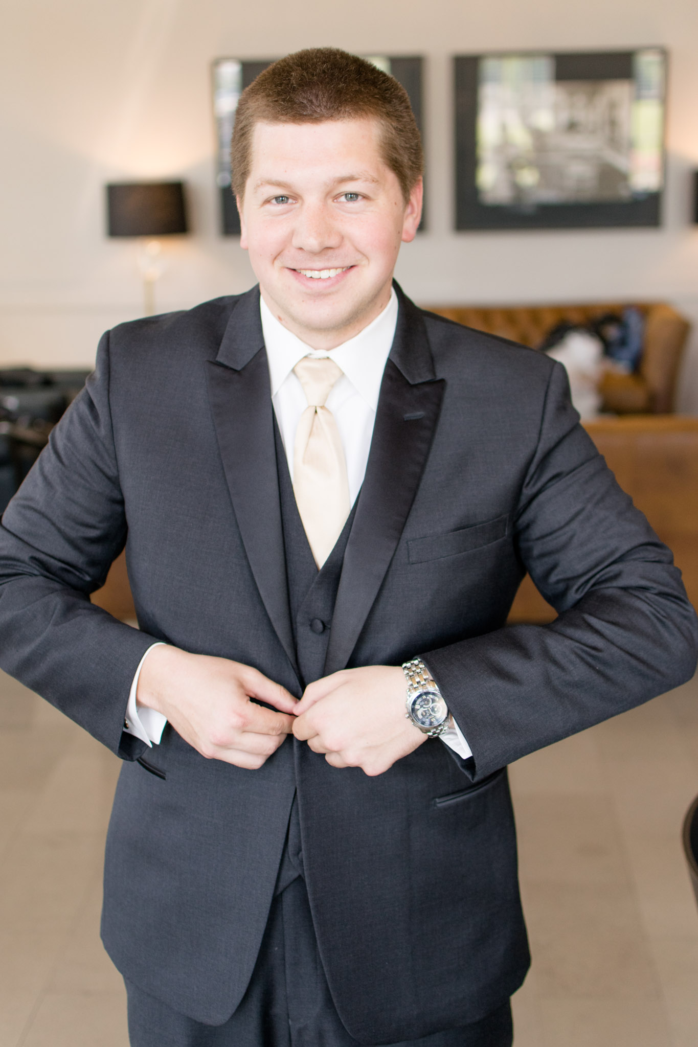 Indianapolis Groom smiles at camera while buttoning jacket