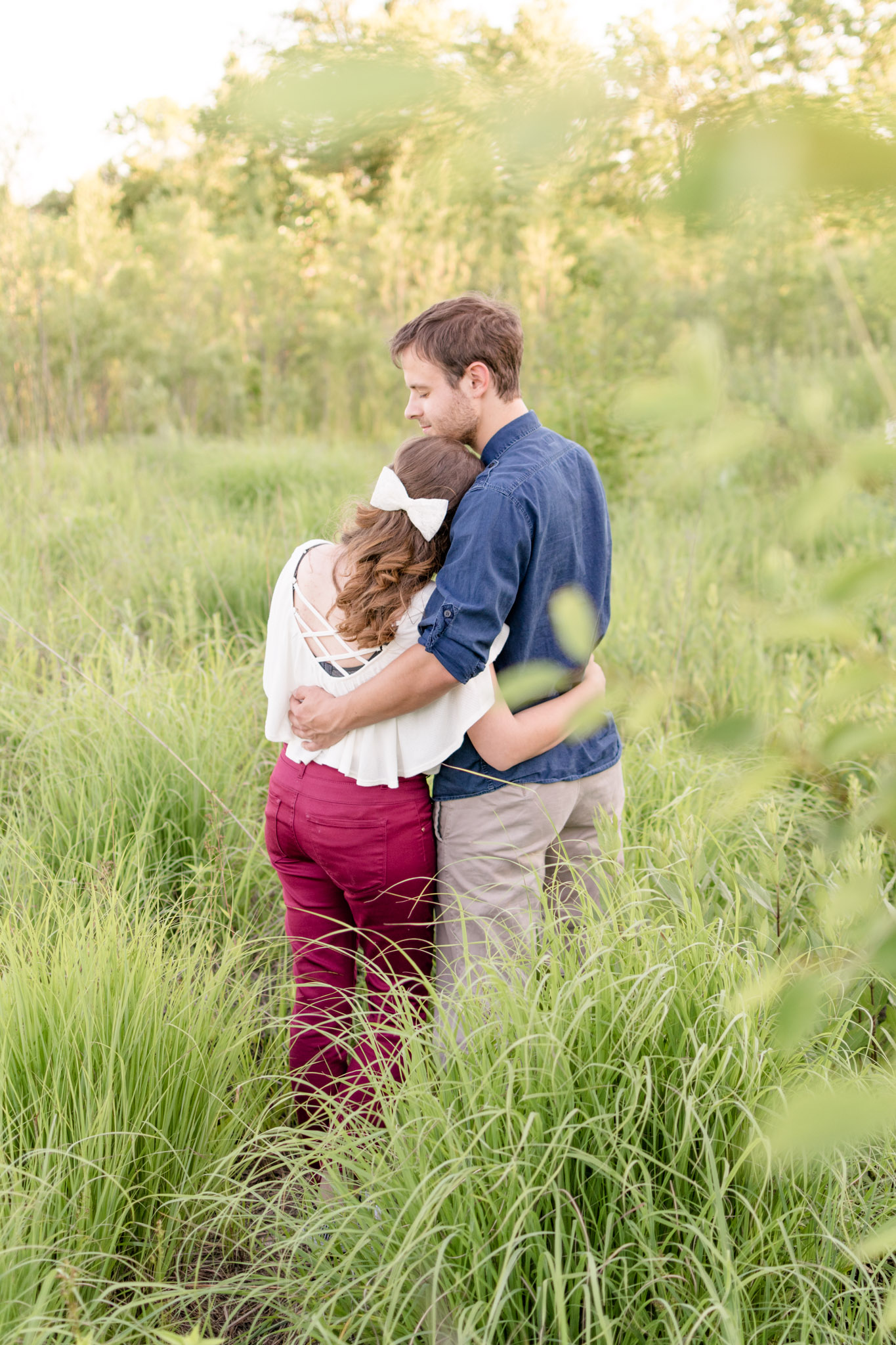 Carmel couple snuggles at West park during engagement session