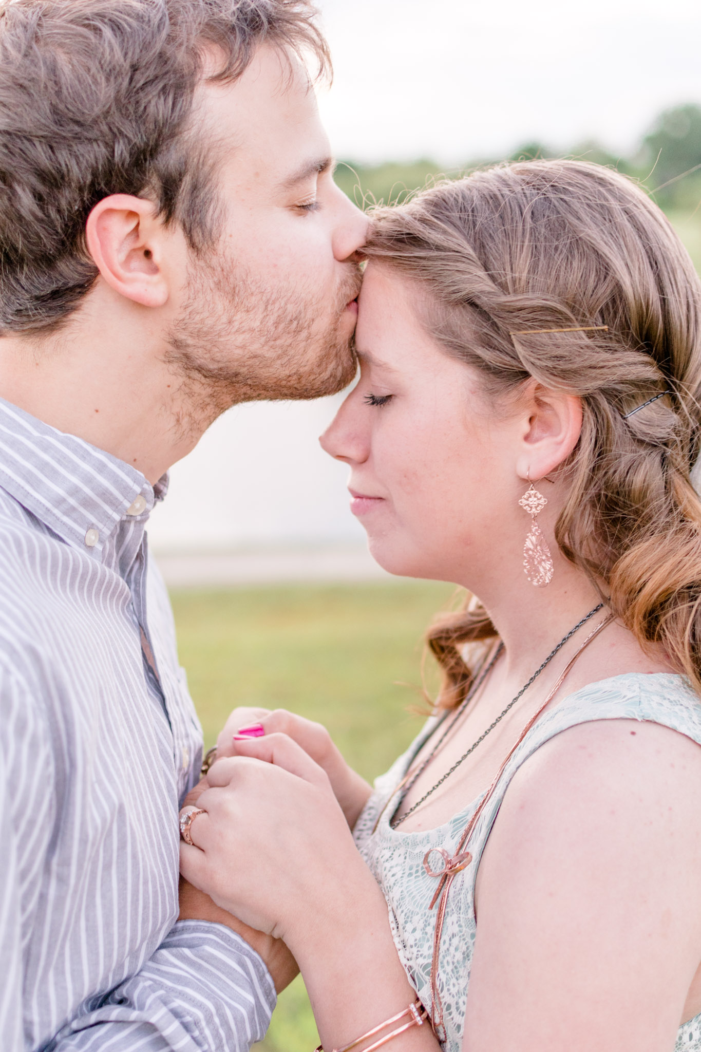 Groom kisses bride on forehead at Carmel's Coxhall Gardens