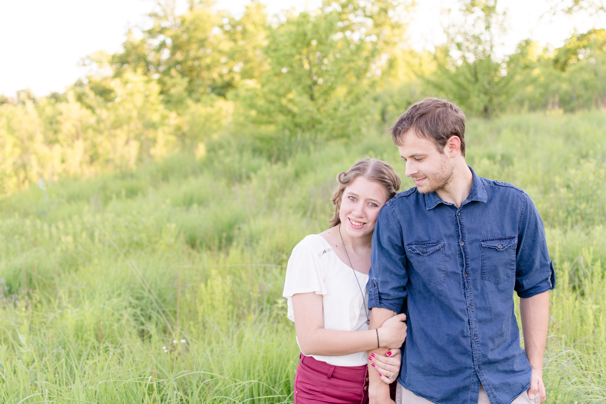 Bride-to-be smiles at camera at West Park field