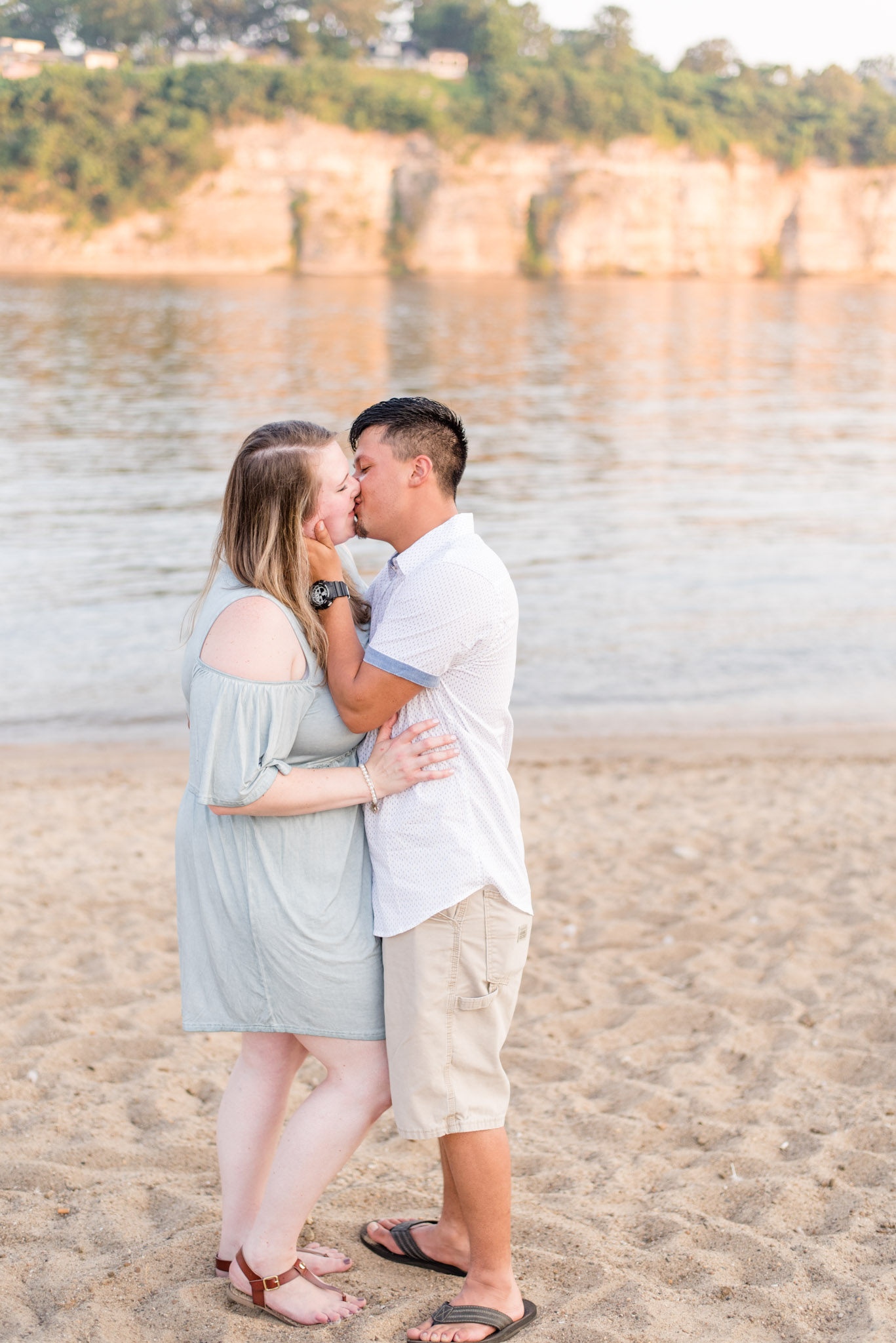 Couple kisses at McFarland Park in Florence Alabama during engagement pictures