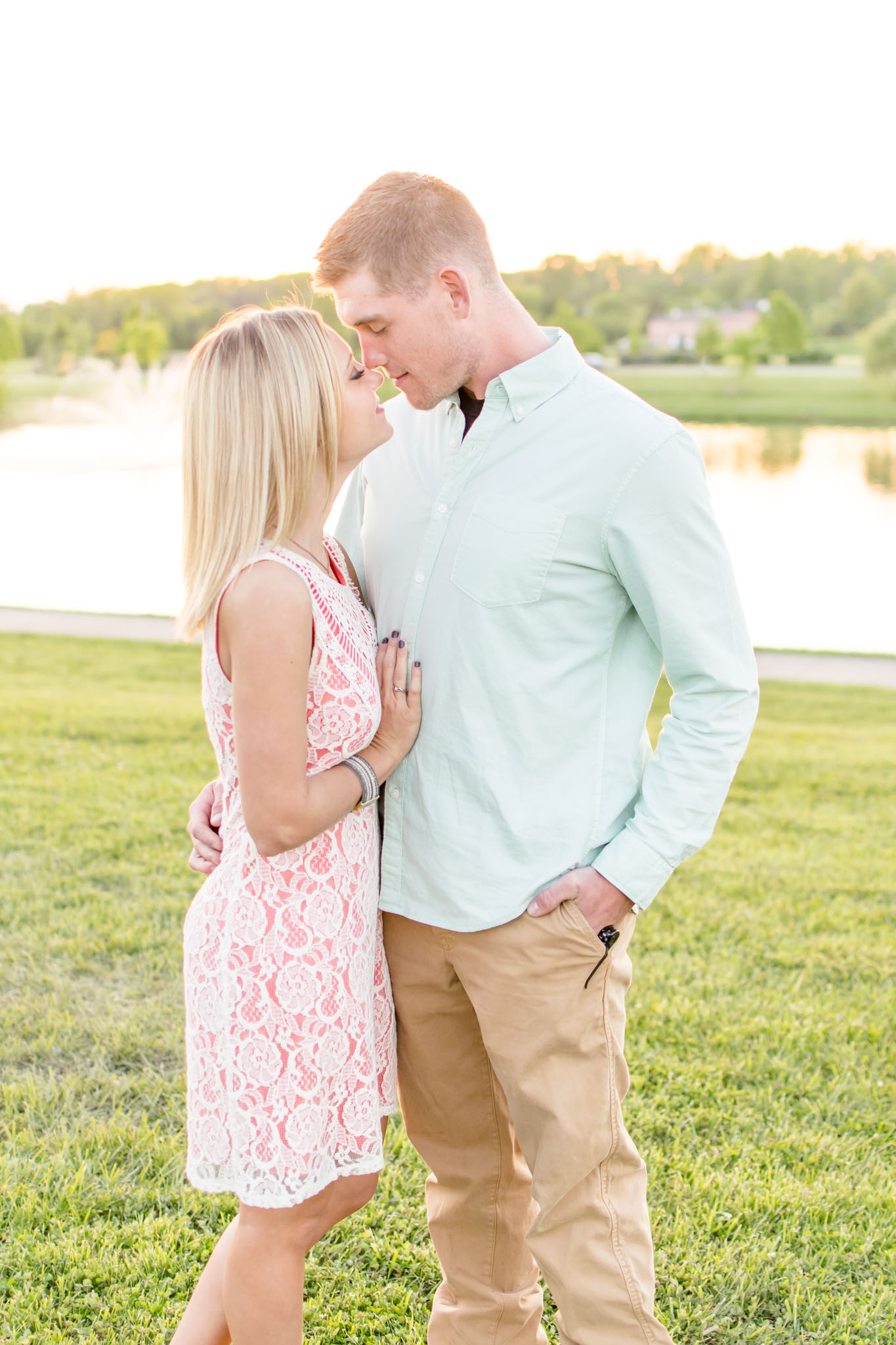 Groom holds bride during Coxhall Gardens sunset engagement pictures.