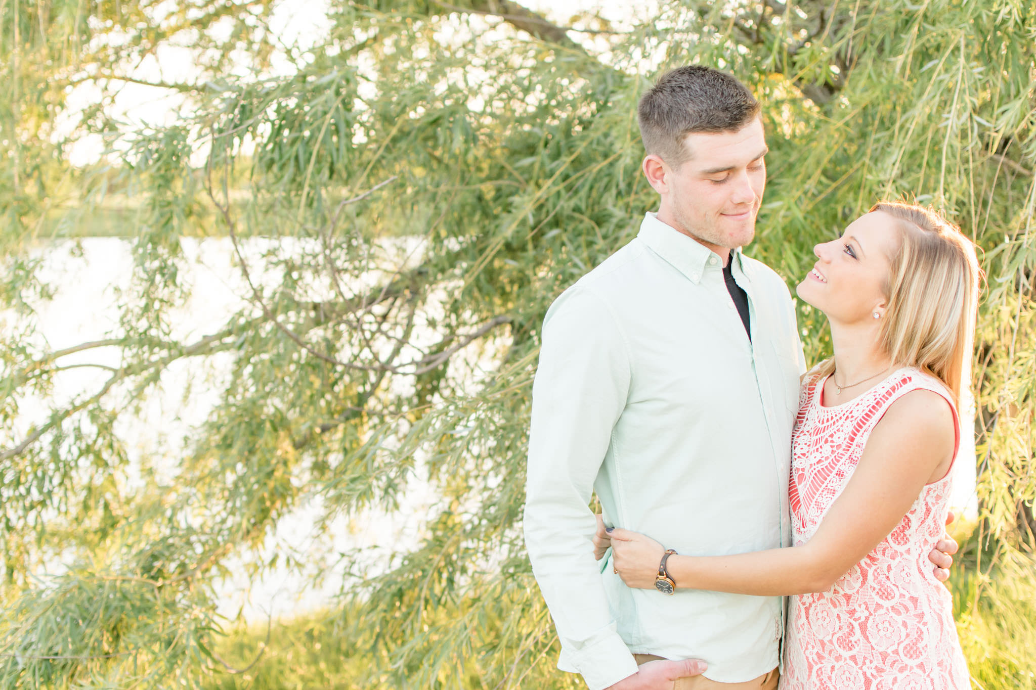 Couple smiles during Coxhall Gardens engagement pictures.