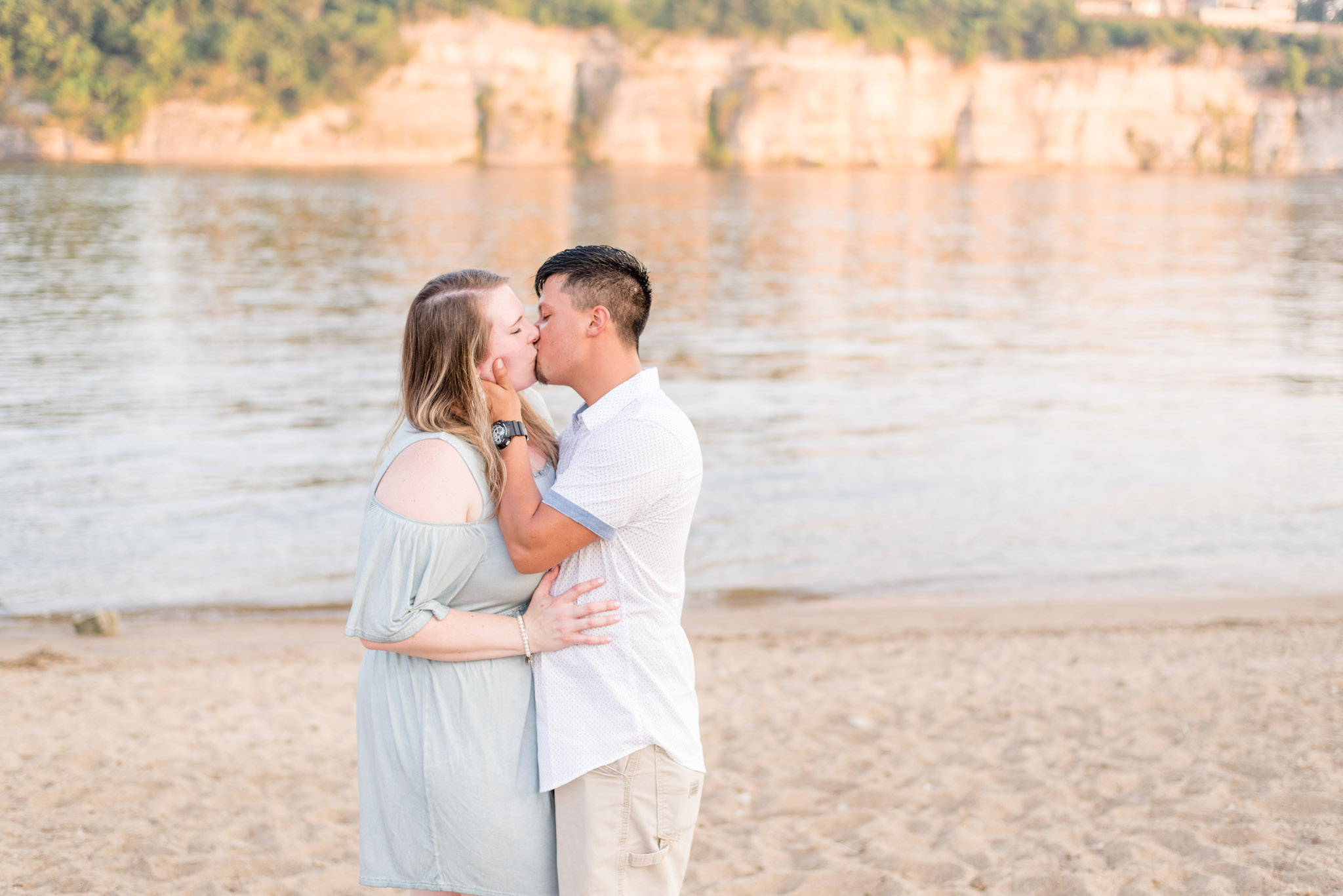 Couple kisses on river during Alabama engagement pictures