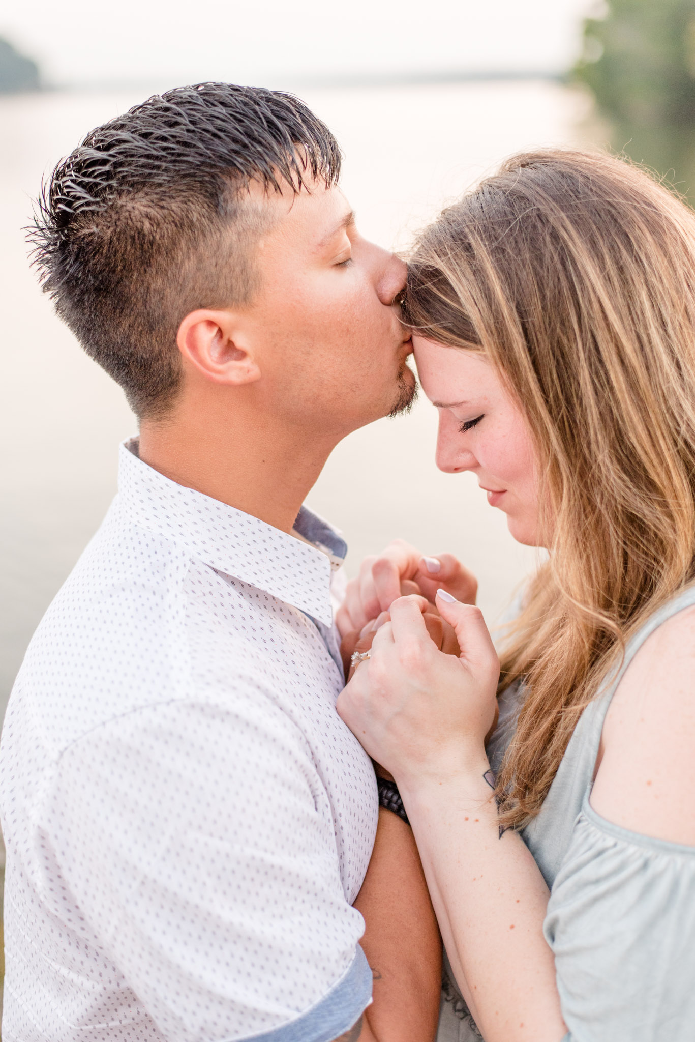 Groom kisses bride on forehead during engagement pictures in North Alabama
