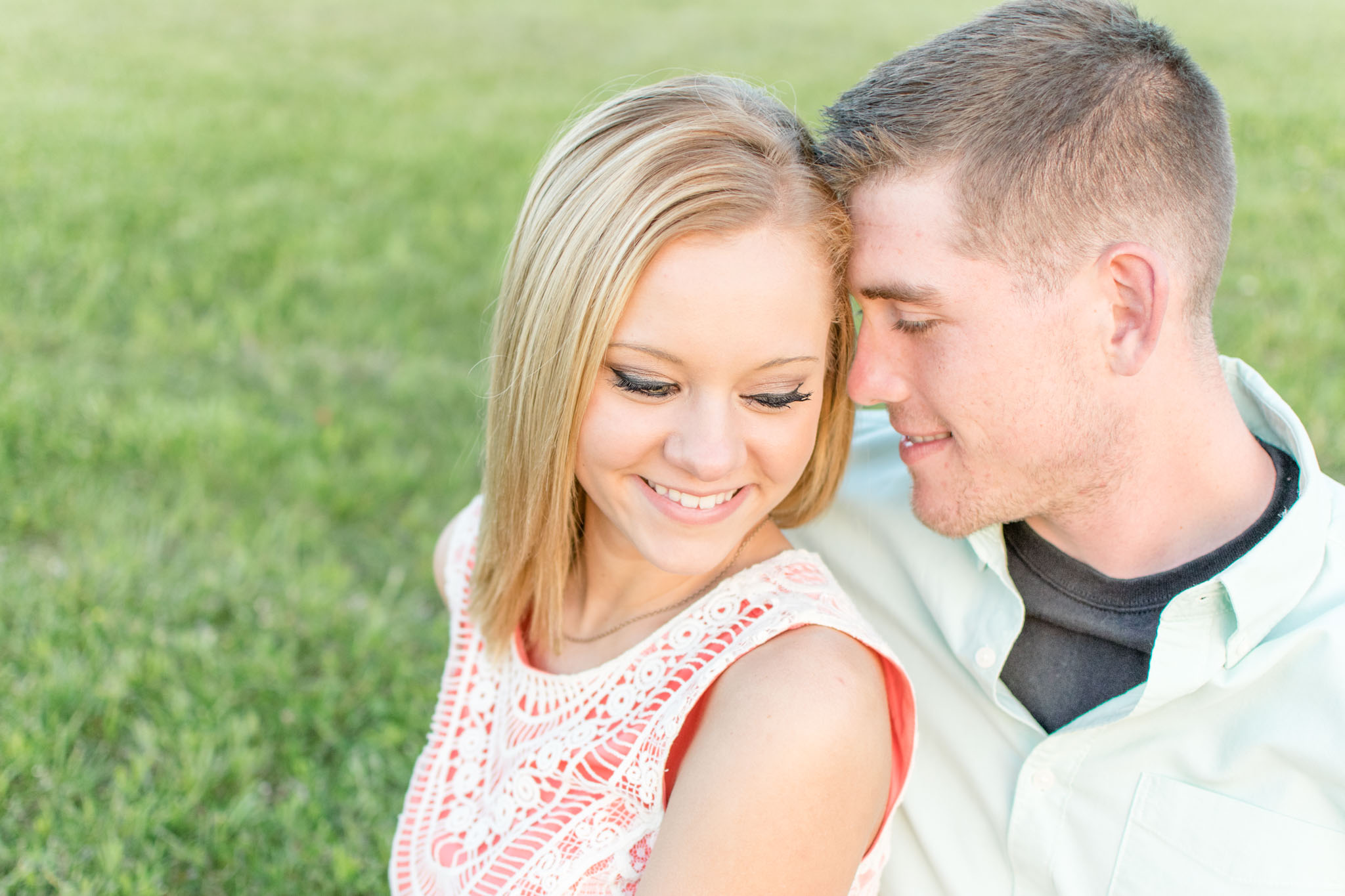 Newlyweds cuddle as they look down.