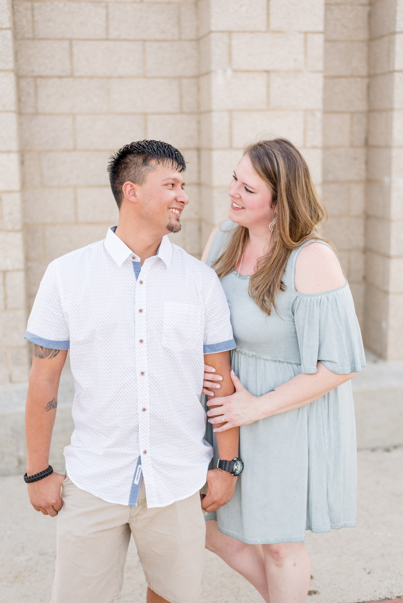 Couple smiles at each other during engagement pictures
