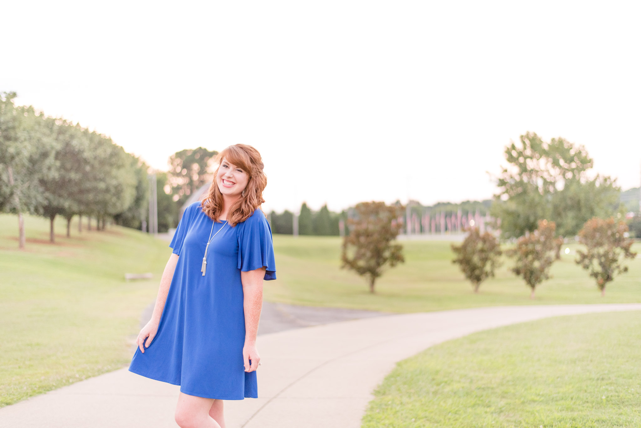 Red-headed model laughs during sunset