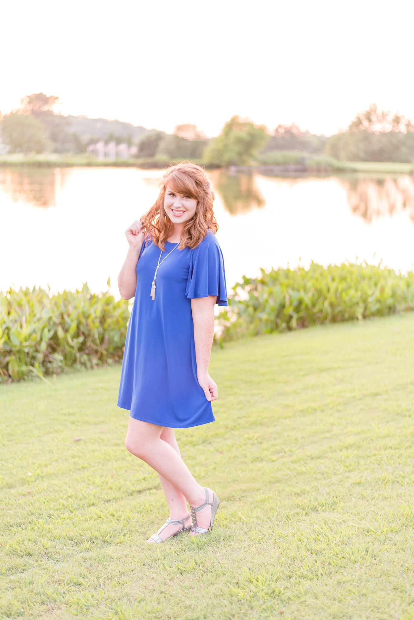 Red-headed senior laughs during pictures