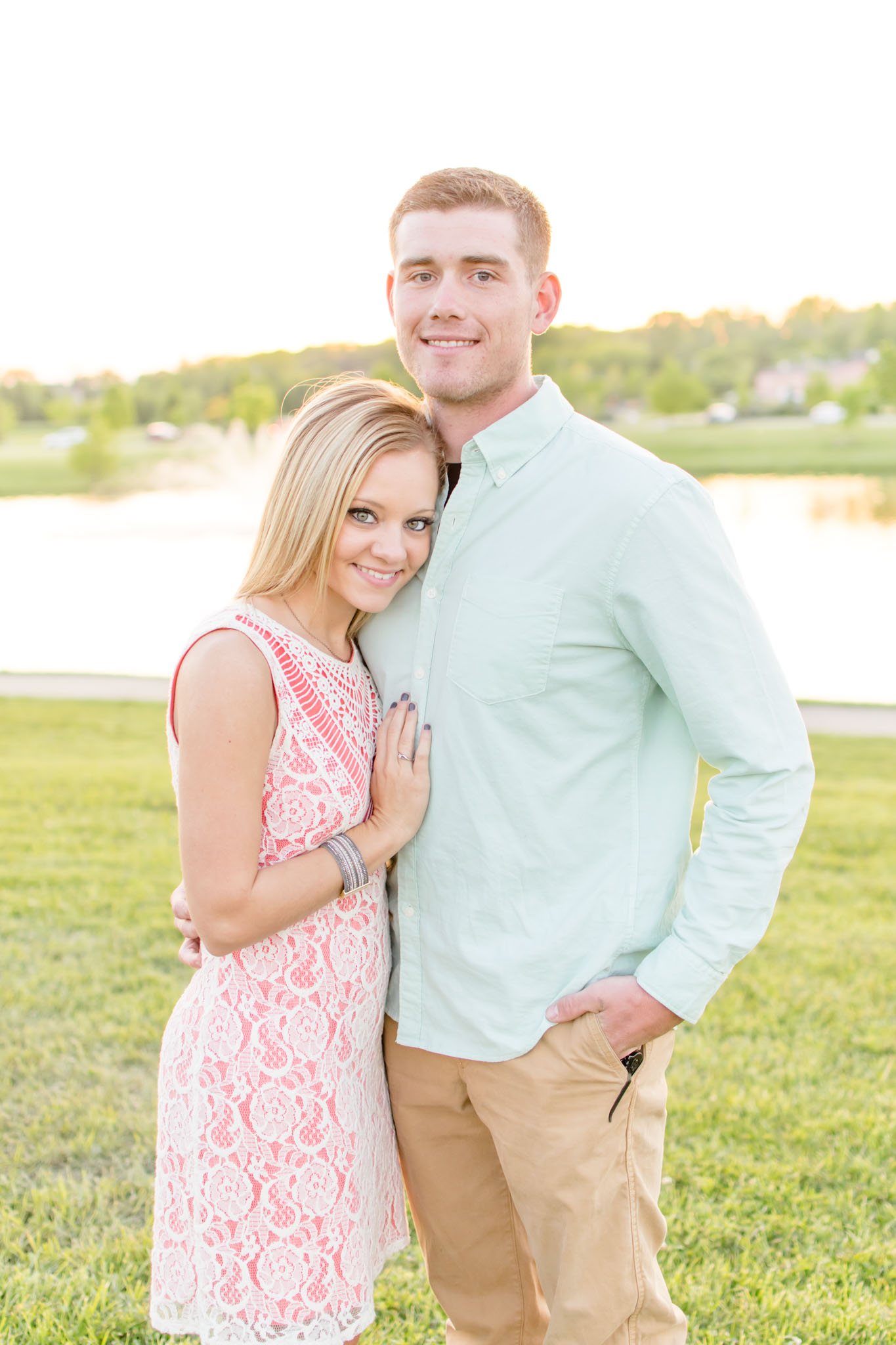 Couple smiles at sunset engagement session at Coxhall Gardens