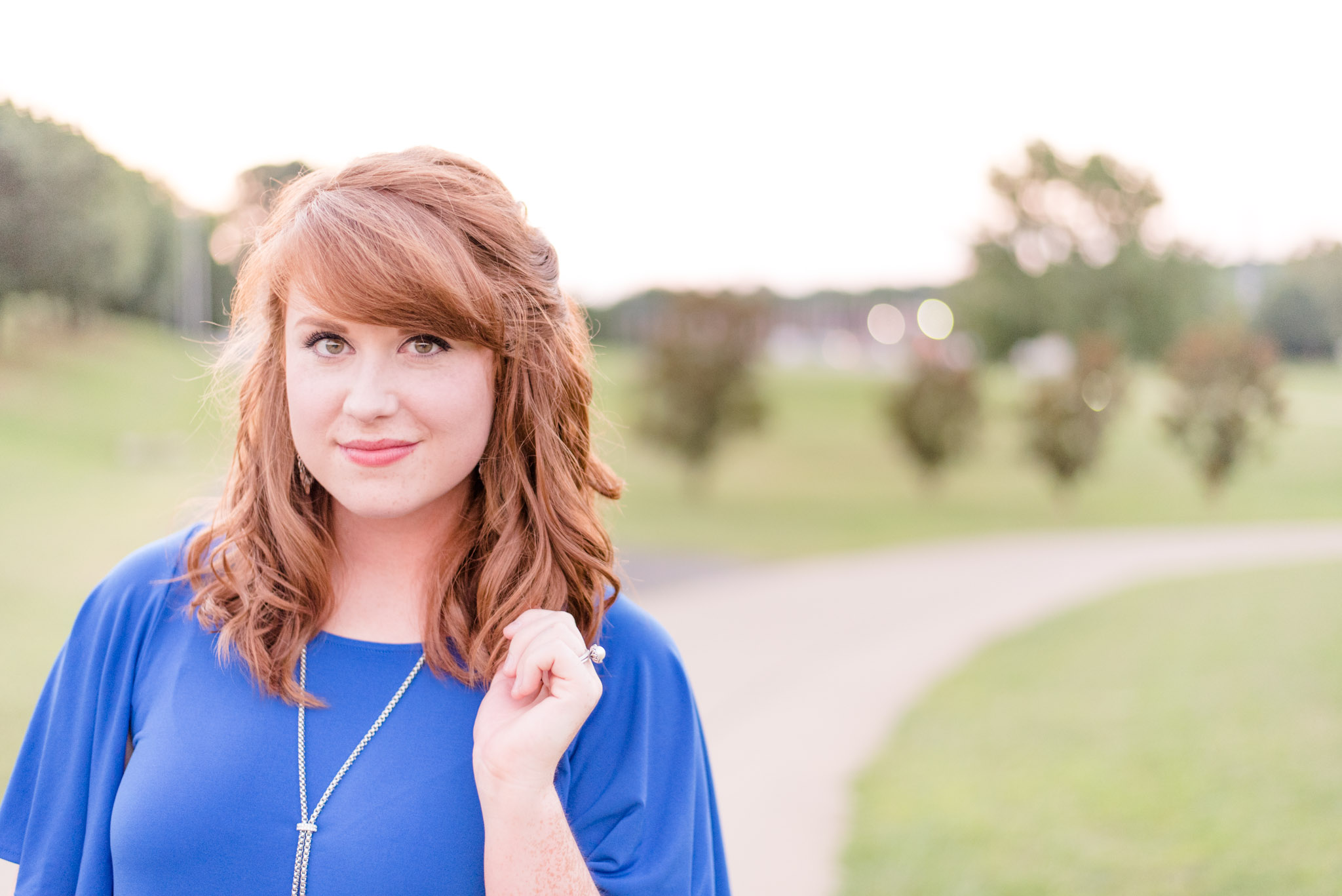 Senior takes pictures at sunset at Deibert Park