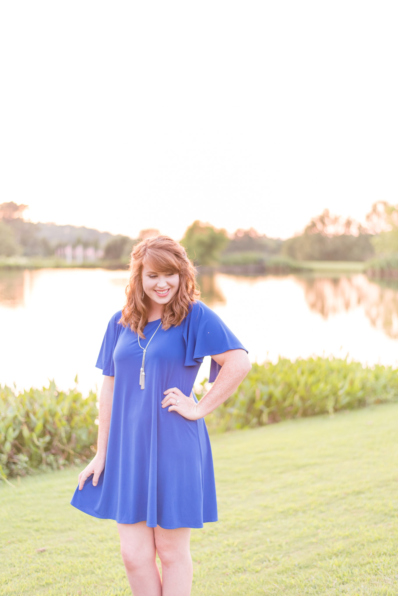 UNA Senior with red hair laughs down shoulder