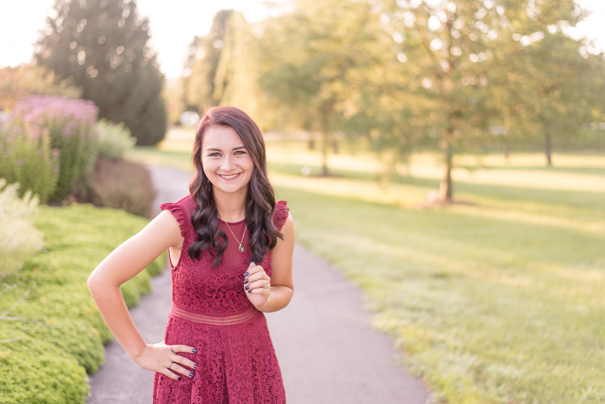 High school senior laughs towards camera.