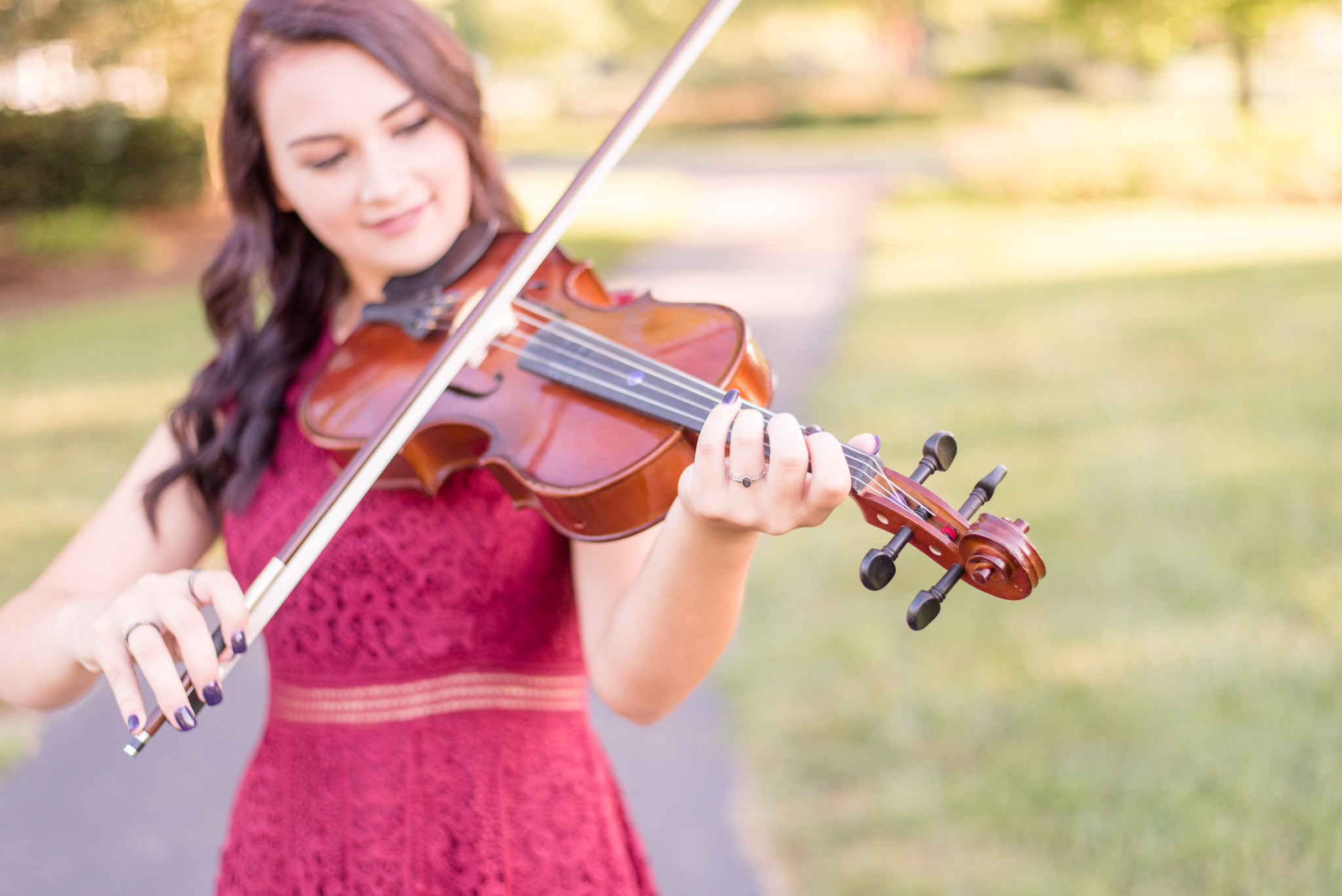 High school senior plays viola during pictures.