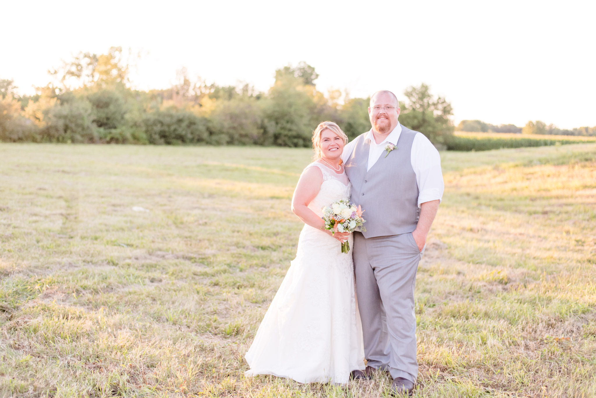 Bride and Groom Smile During Sunset Portraits