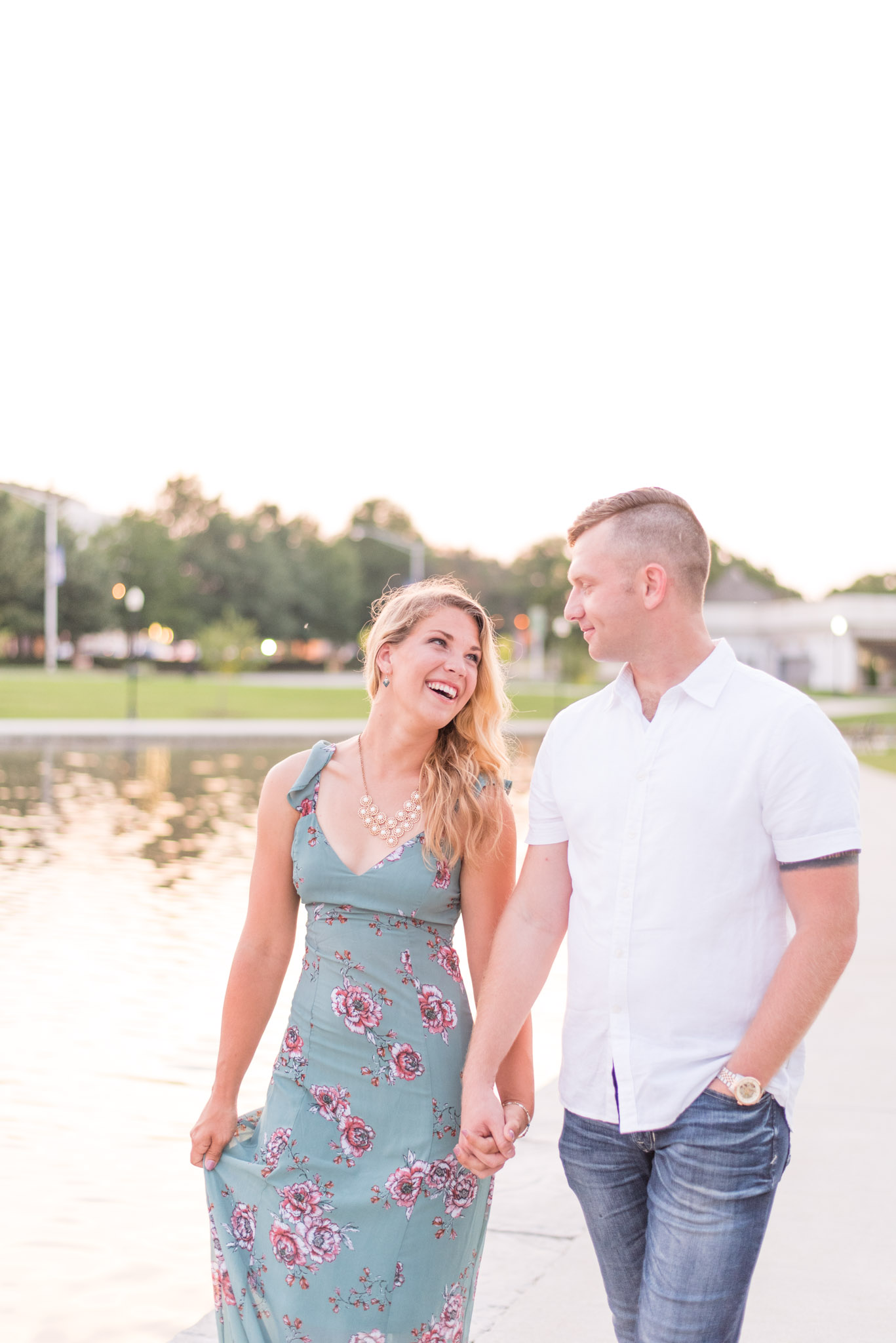 Engaged Couple Laughs While Walking in Big Spring Park. 