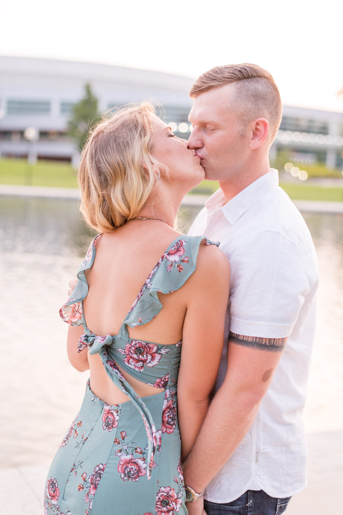 Huntsville couple kisses in front of lake in Alabama.