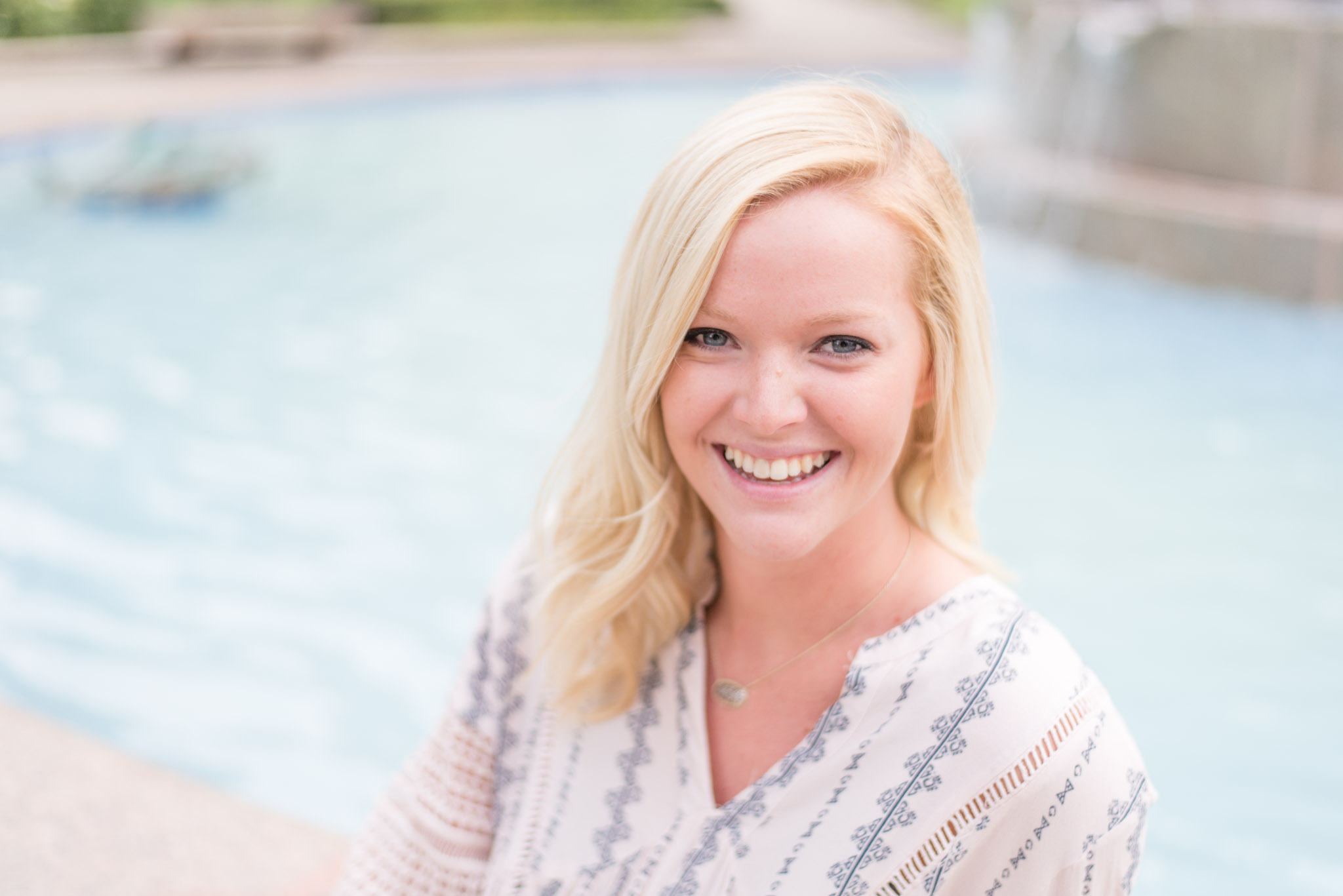 Girl laughs at downtown fountain.