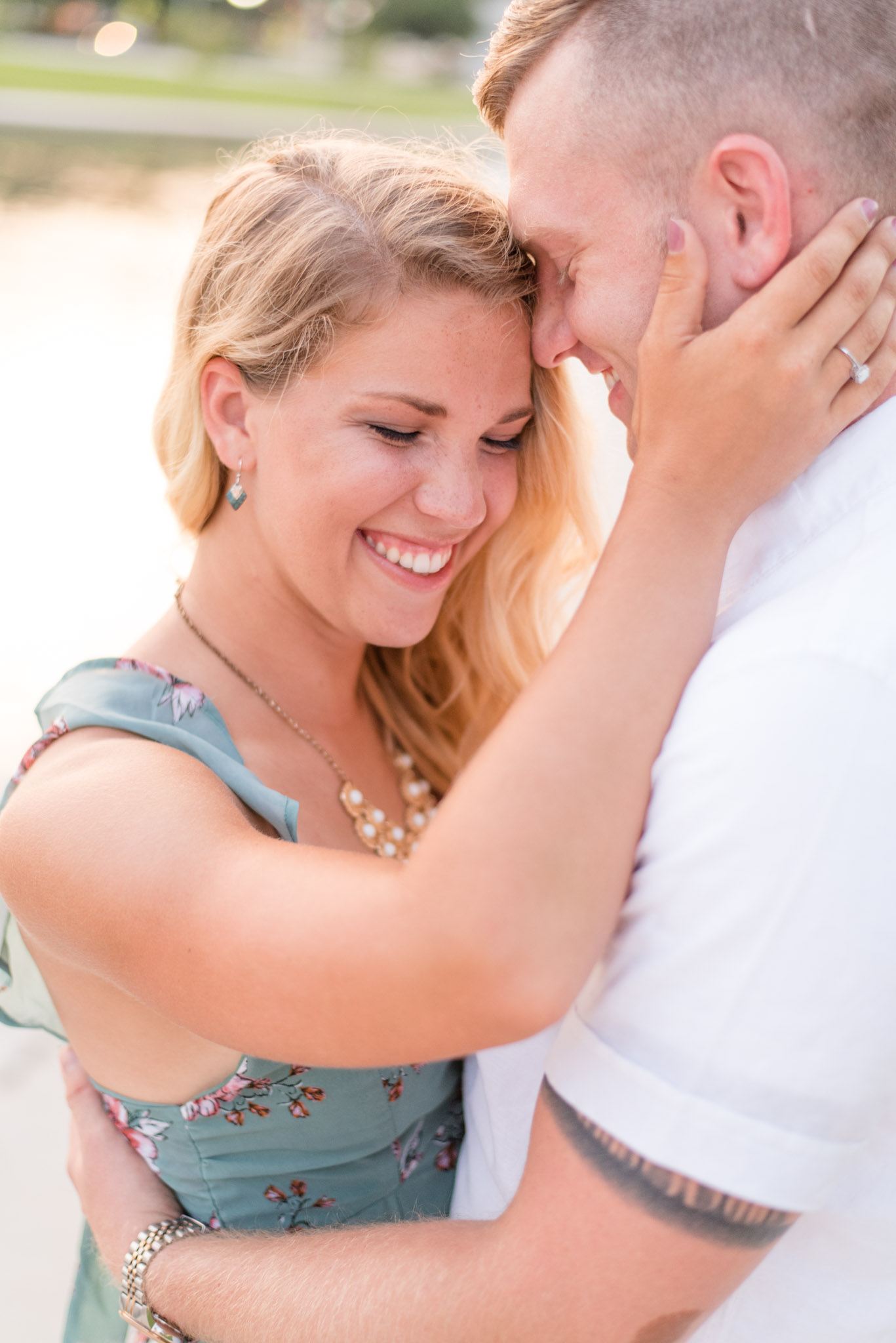 Engaged couple smiles during engagement pictures. 