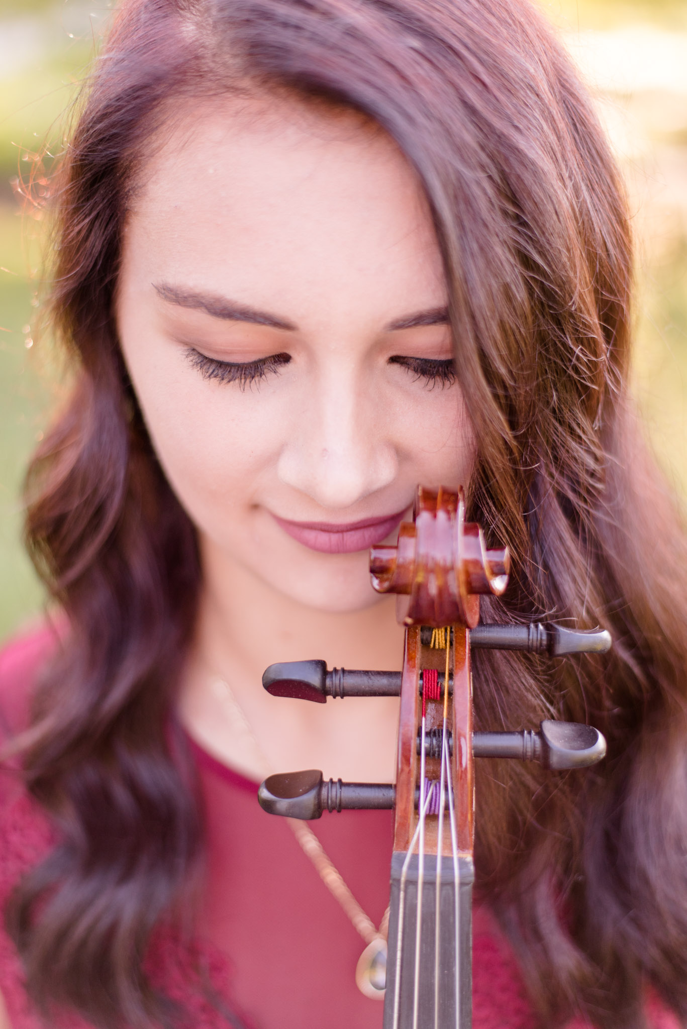 High school senior poses with tip of viola