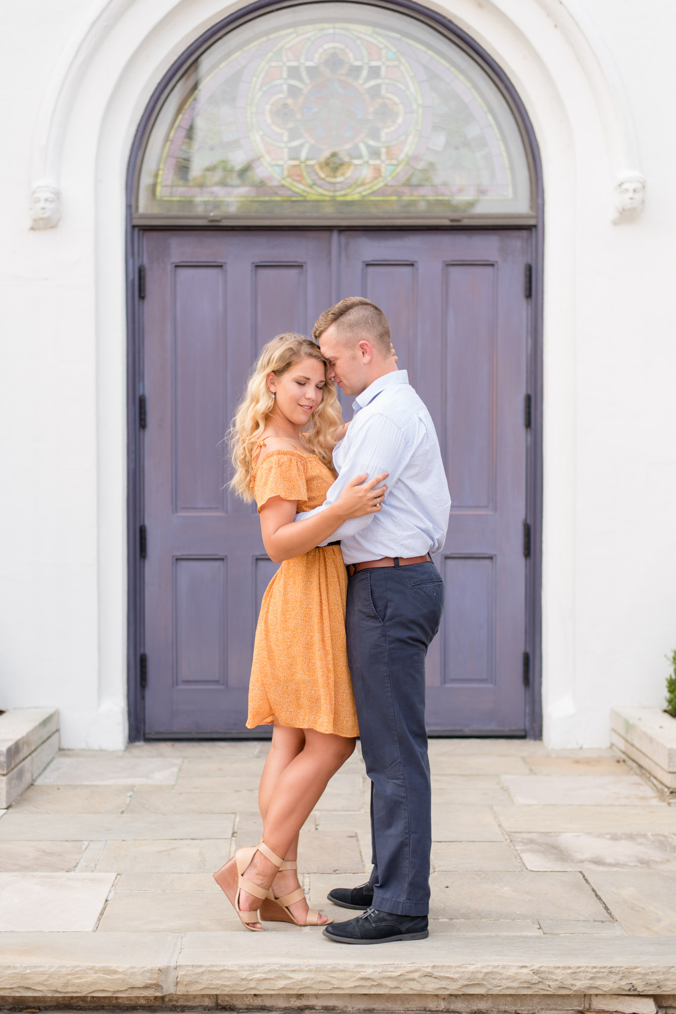 Alabama couple snuggles in front of purple door.