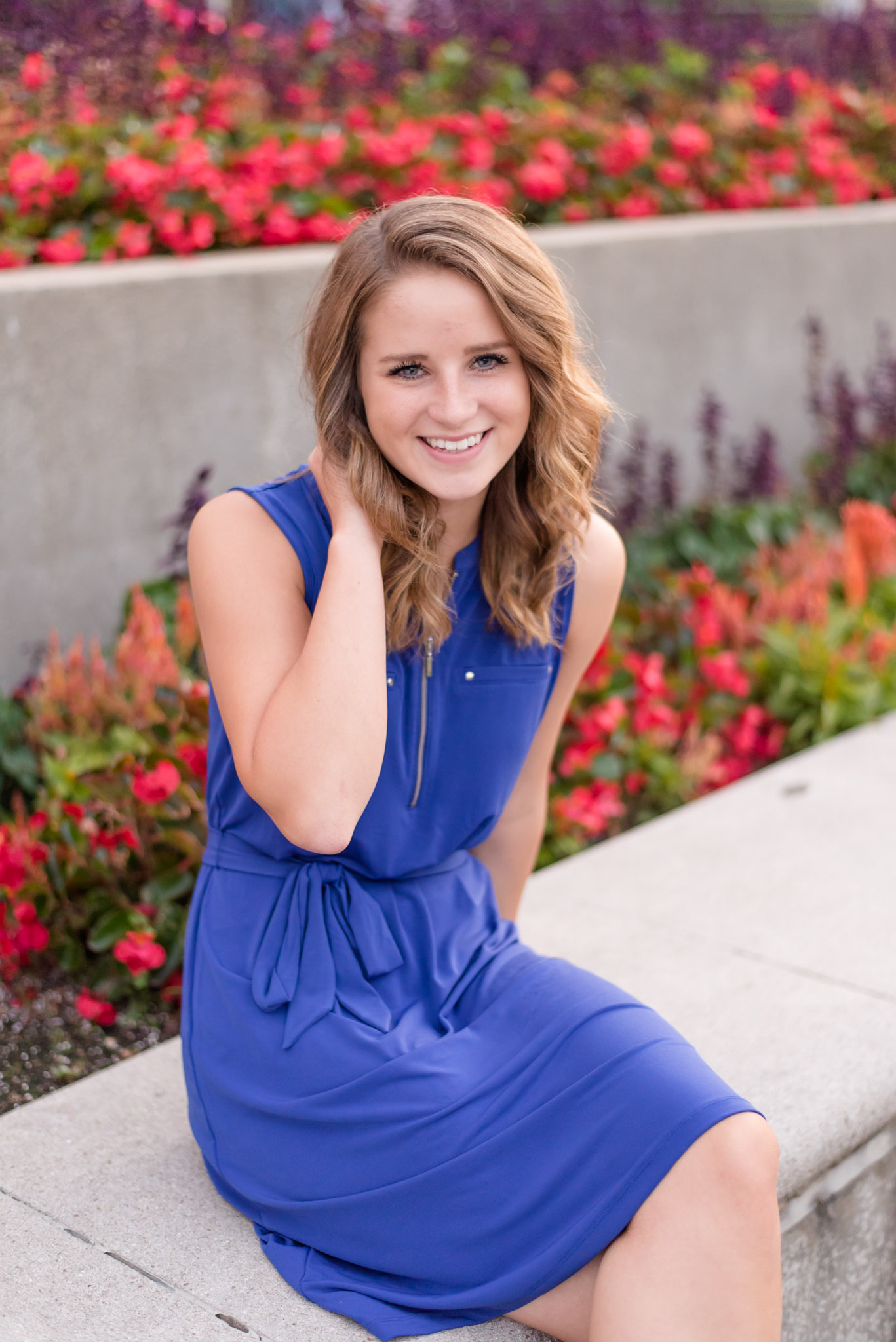 Indianapolis Senior sits in front of flowers