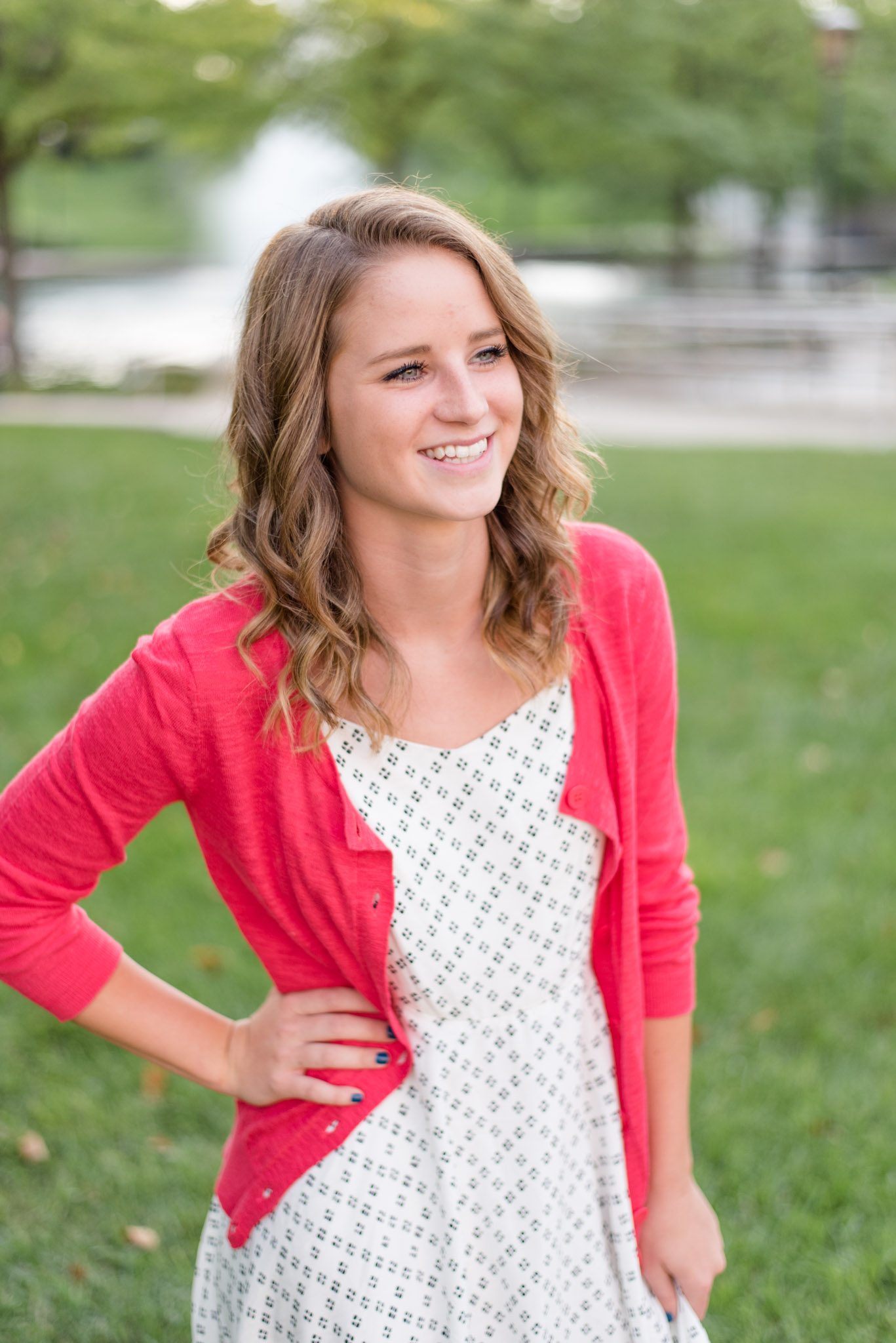 Senior smiles over shoulder in Indianapolis Canal