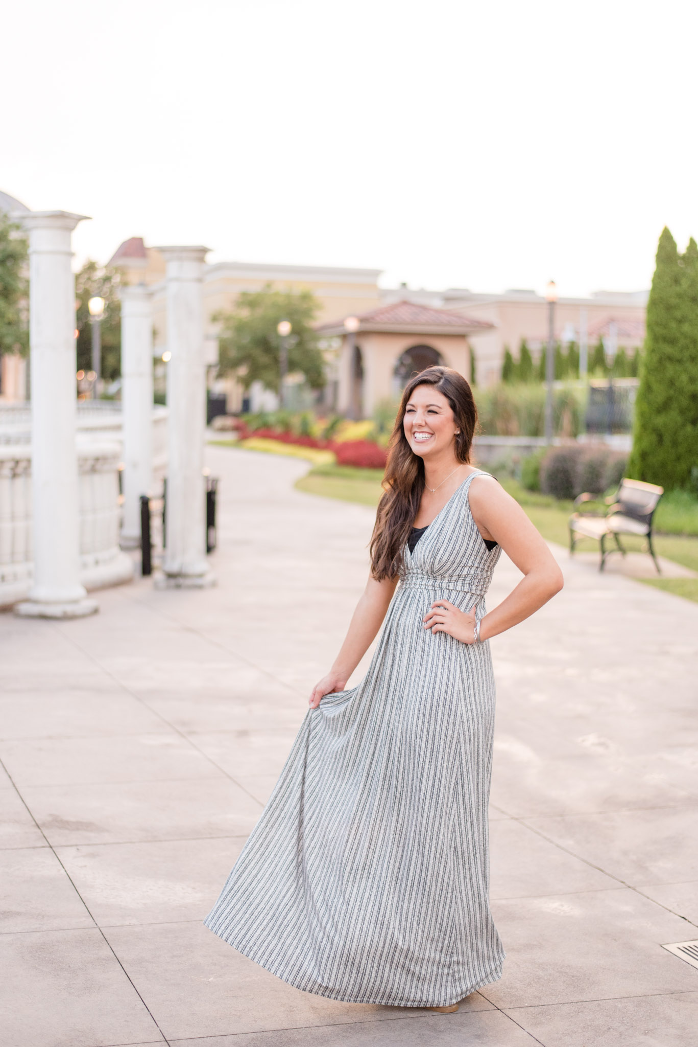 North Alabama girl laughs as she holds her dress.