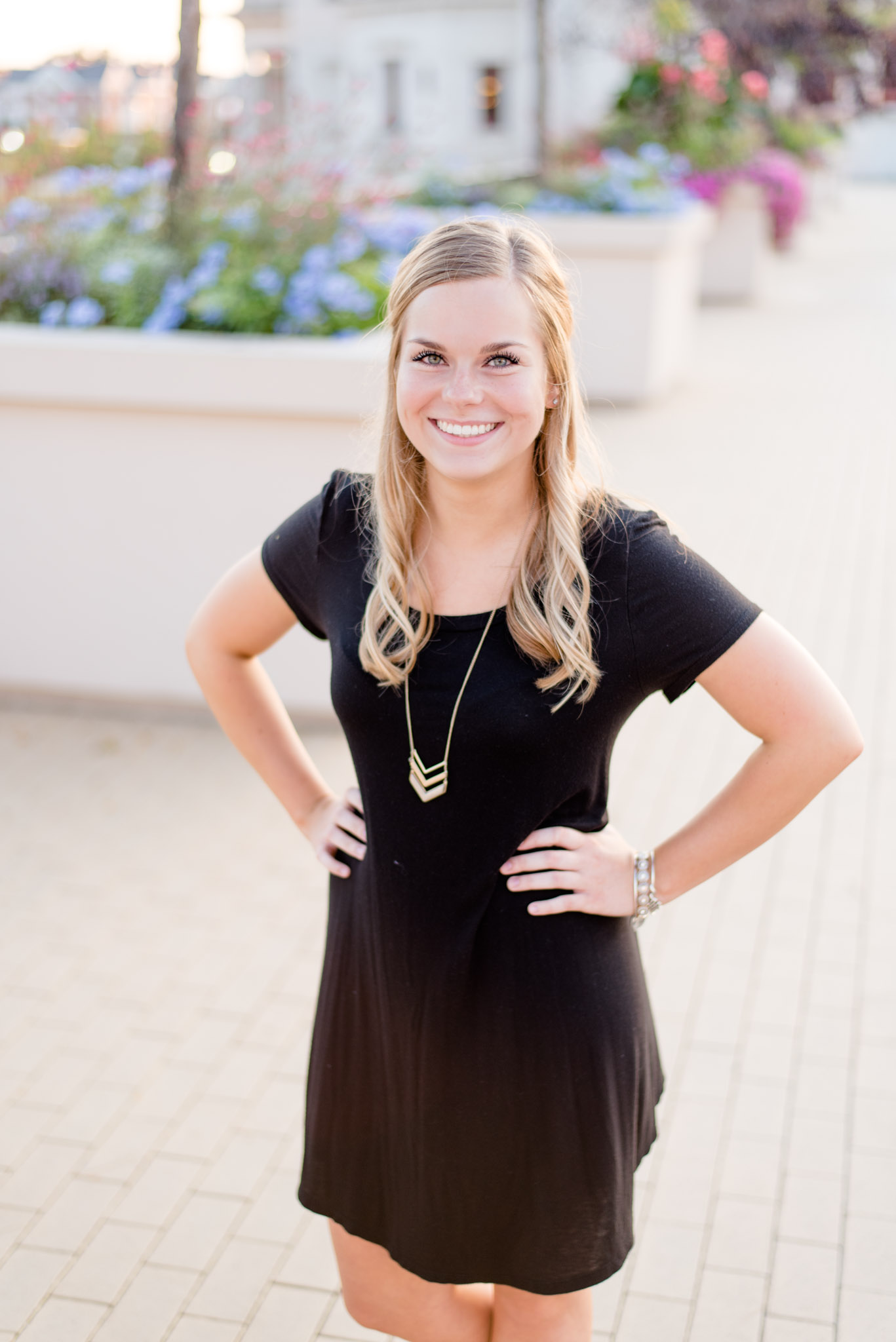 Indianapolis realtor smiles with hands on hips.