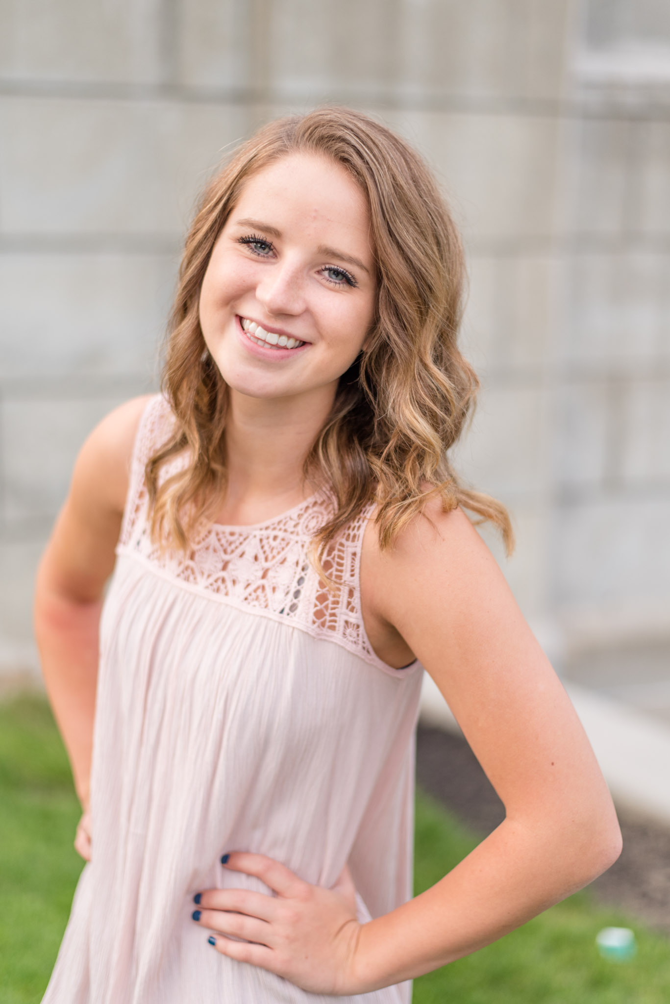 High School Senior smiles next to river walk.