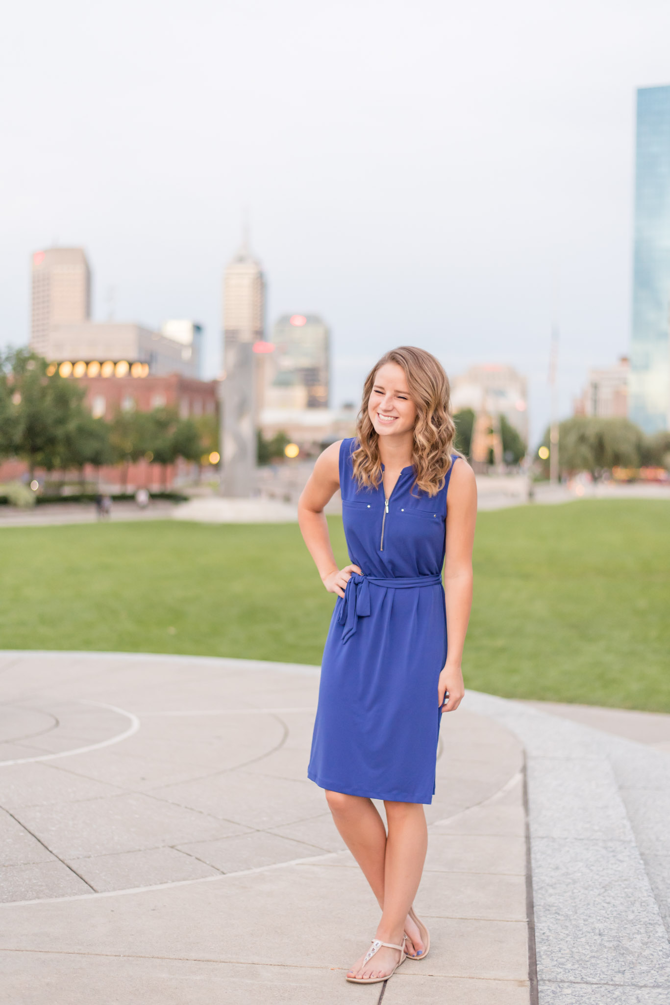 High School Senior laughs with Indianapolis backdrop