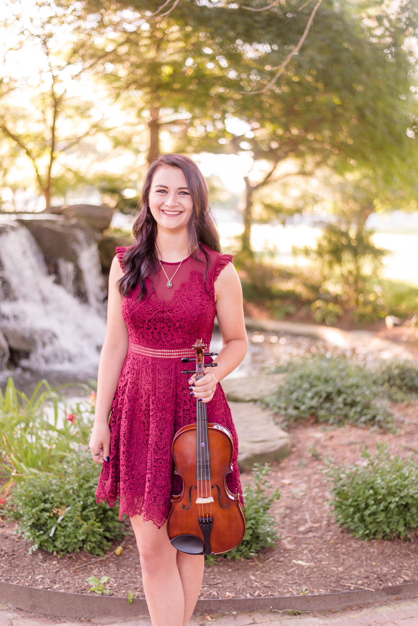 High school senior holds viola.