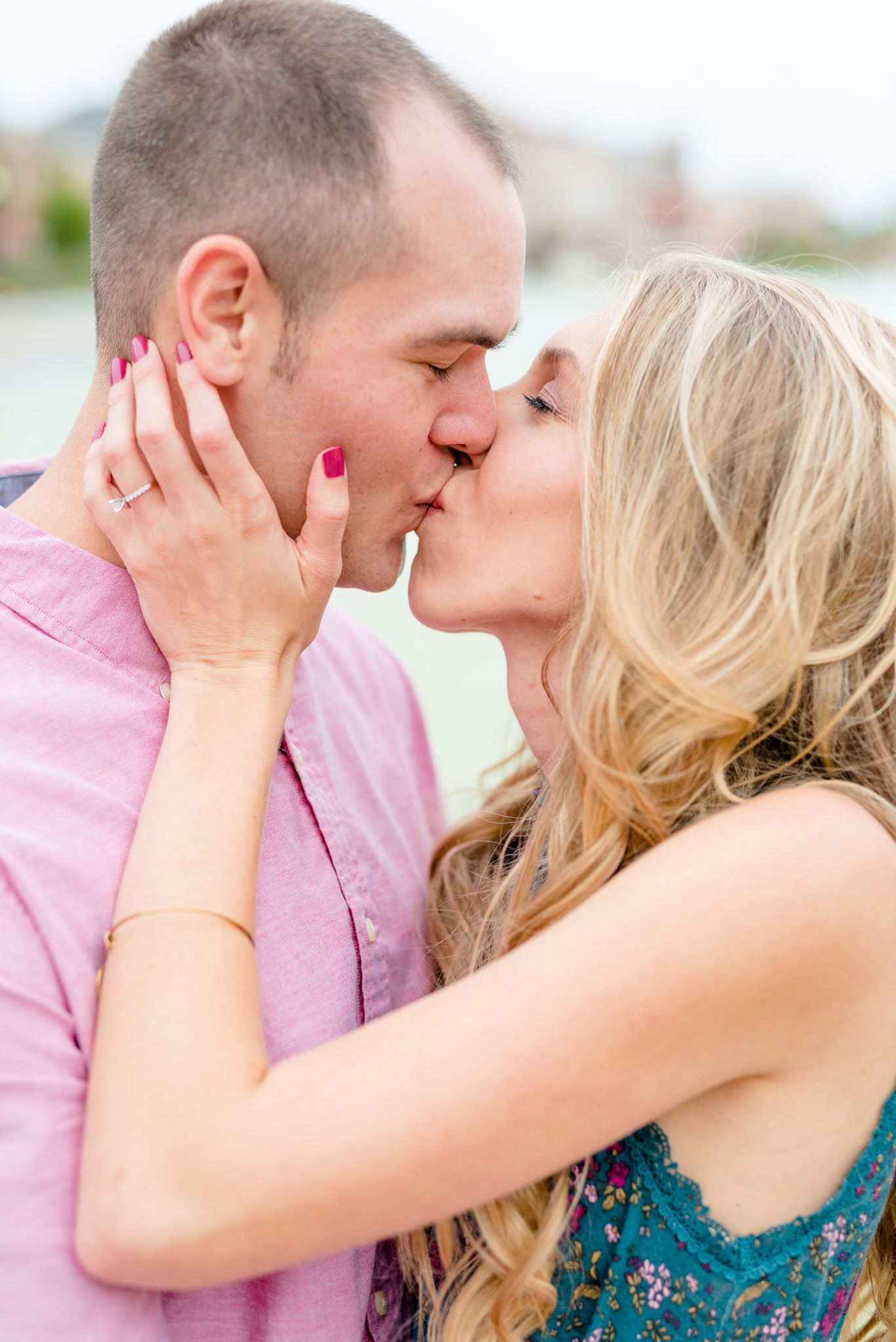 Bride and groom kiss during engagement session.