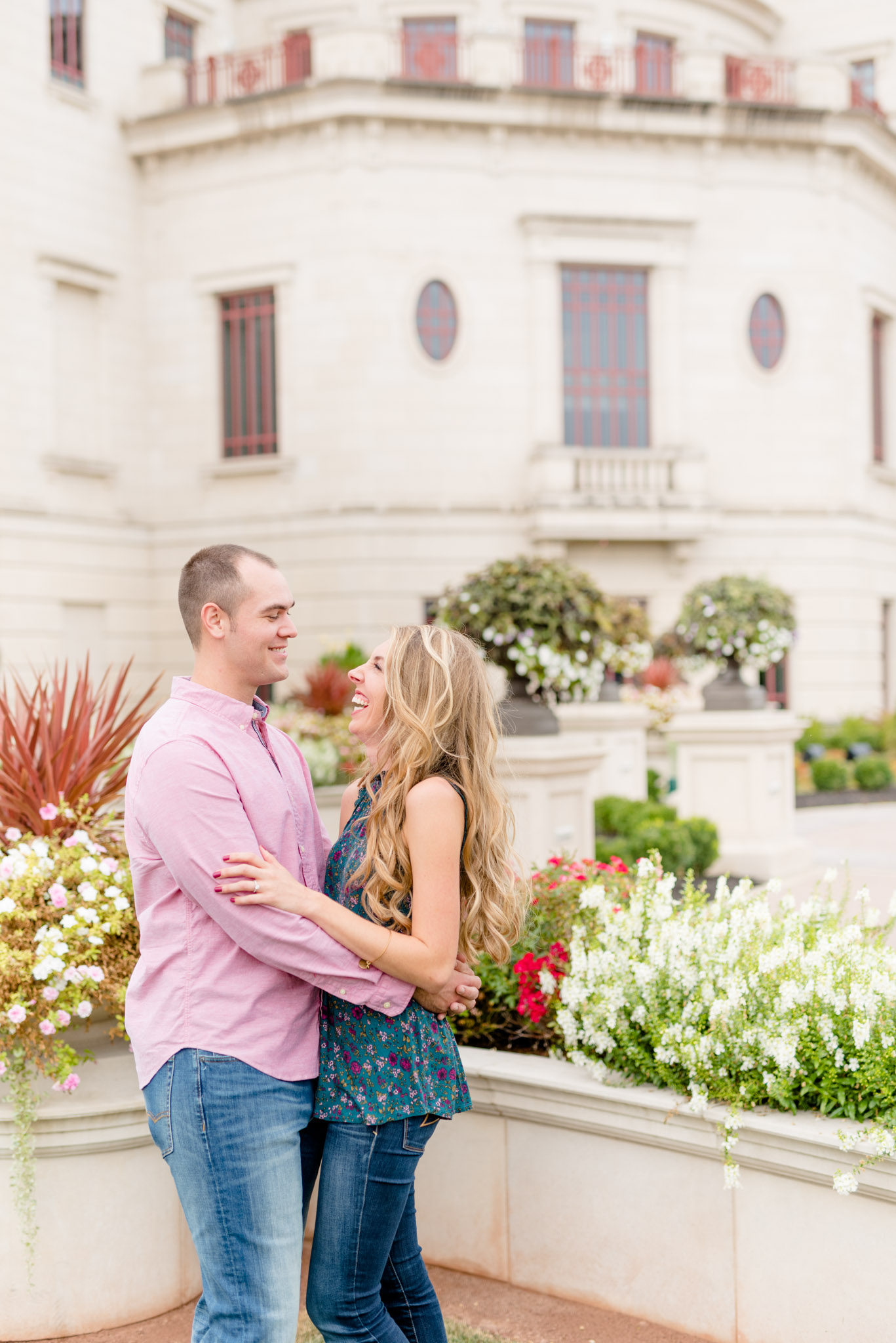 Couple laughs in front of the Carmel Palladium.