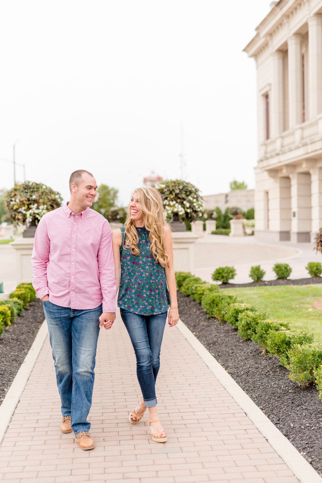 Indianapolis couple walks next to Carmel Palladium.