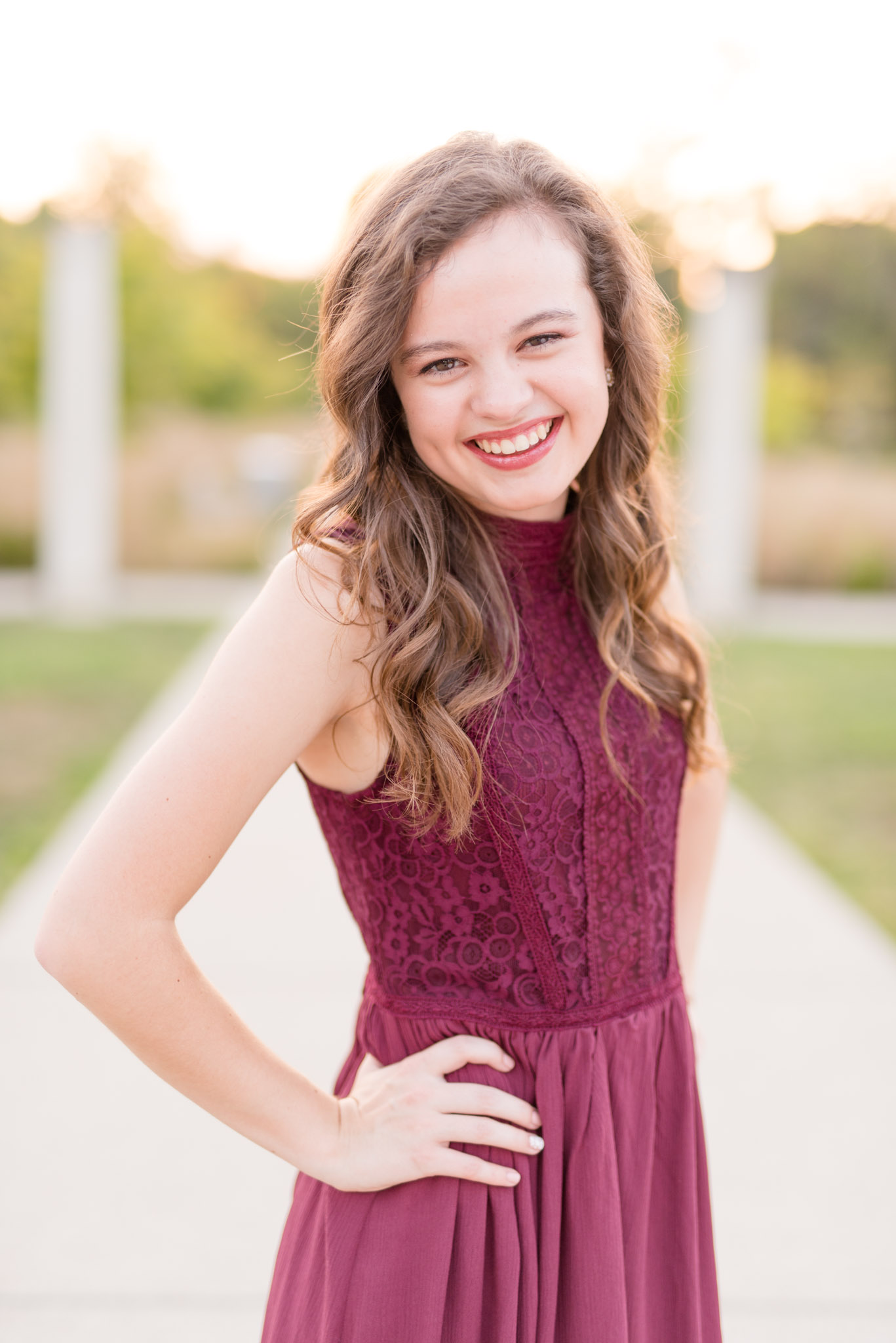 Senior girl laughs at sunset.