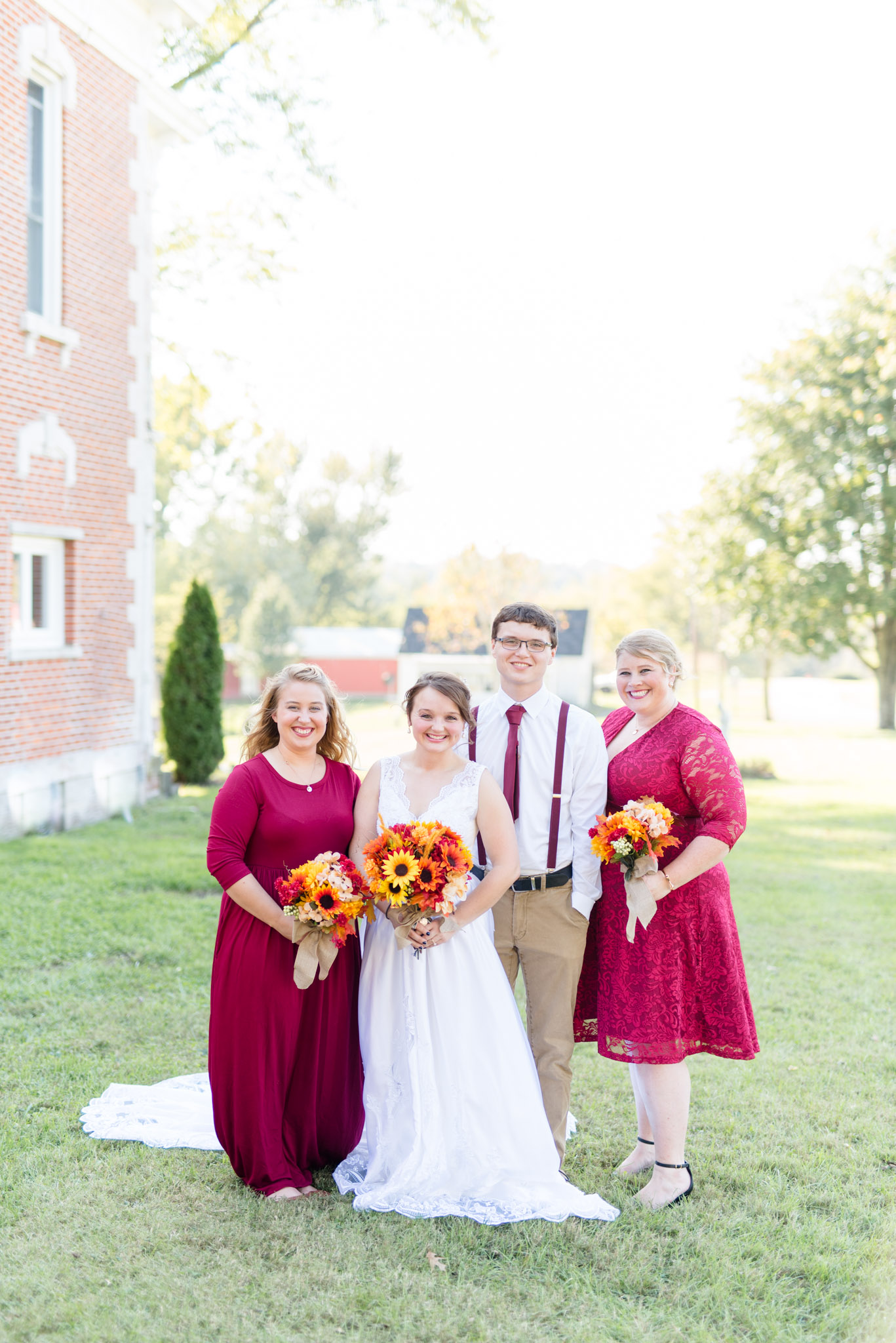Bridal Party Smiles at Camera while Dressed in Burgundy