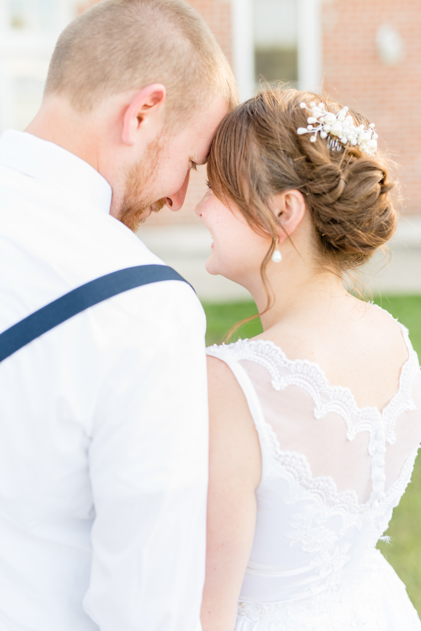 Bride and Groom Touch Foreheads and Smile