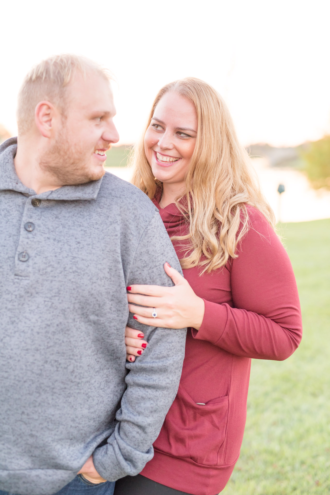 Woman looks at fiance and smiles.